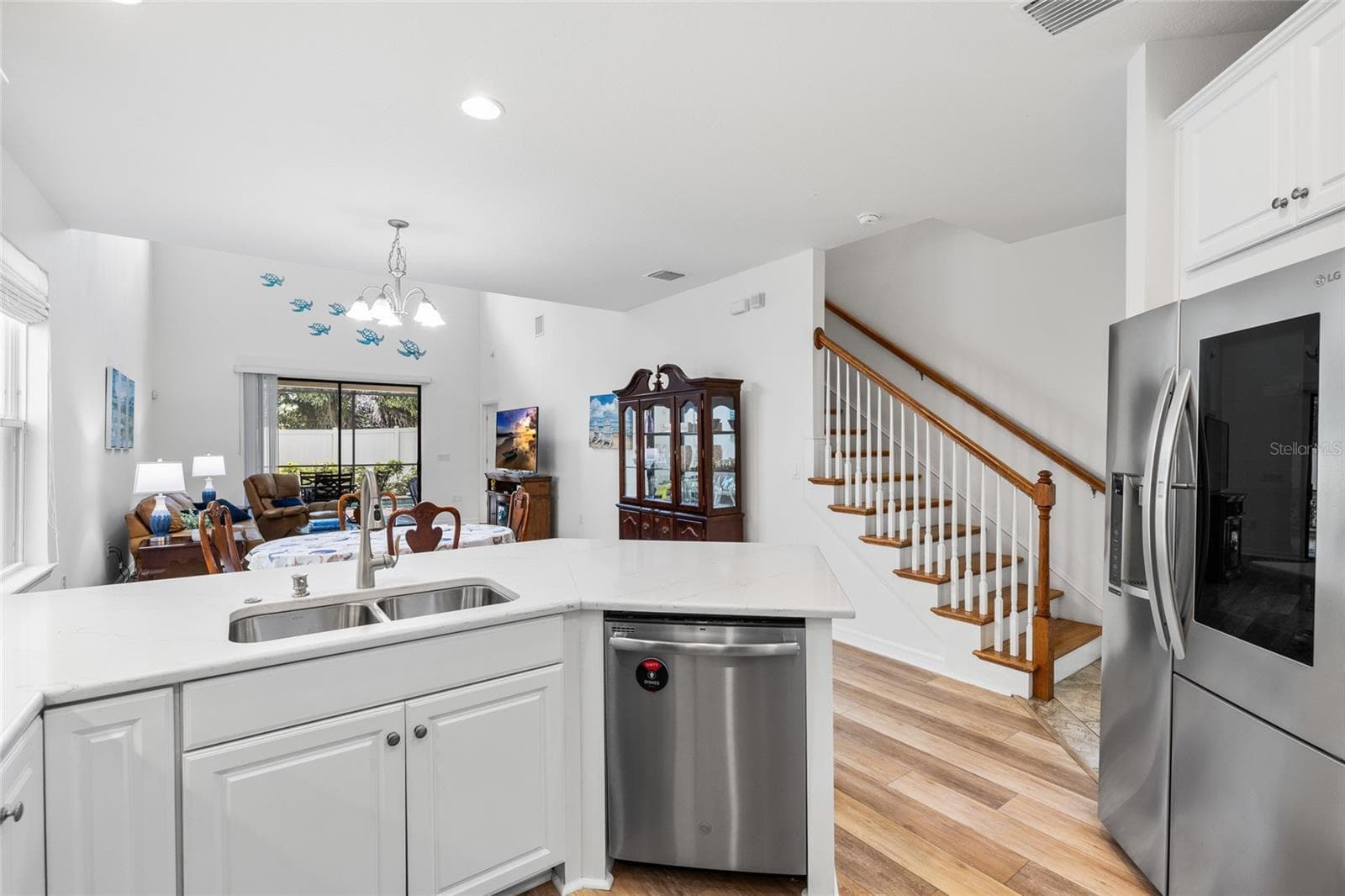 Kitchen looking toward dining room, and great room out to the pool. - 8519 ARABELLA LN, SEMINOLE