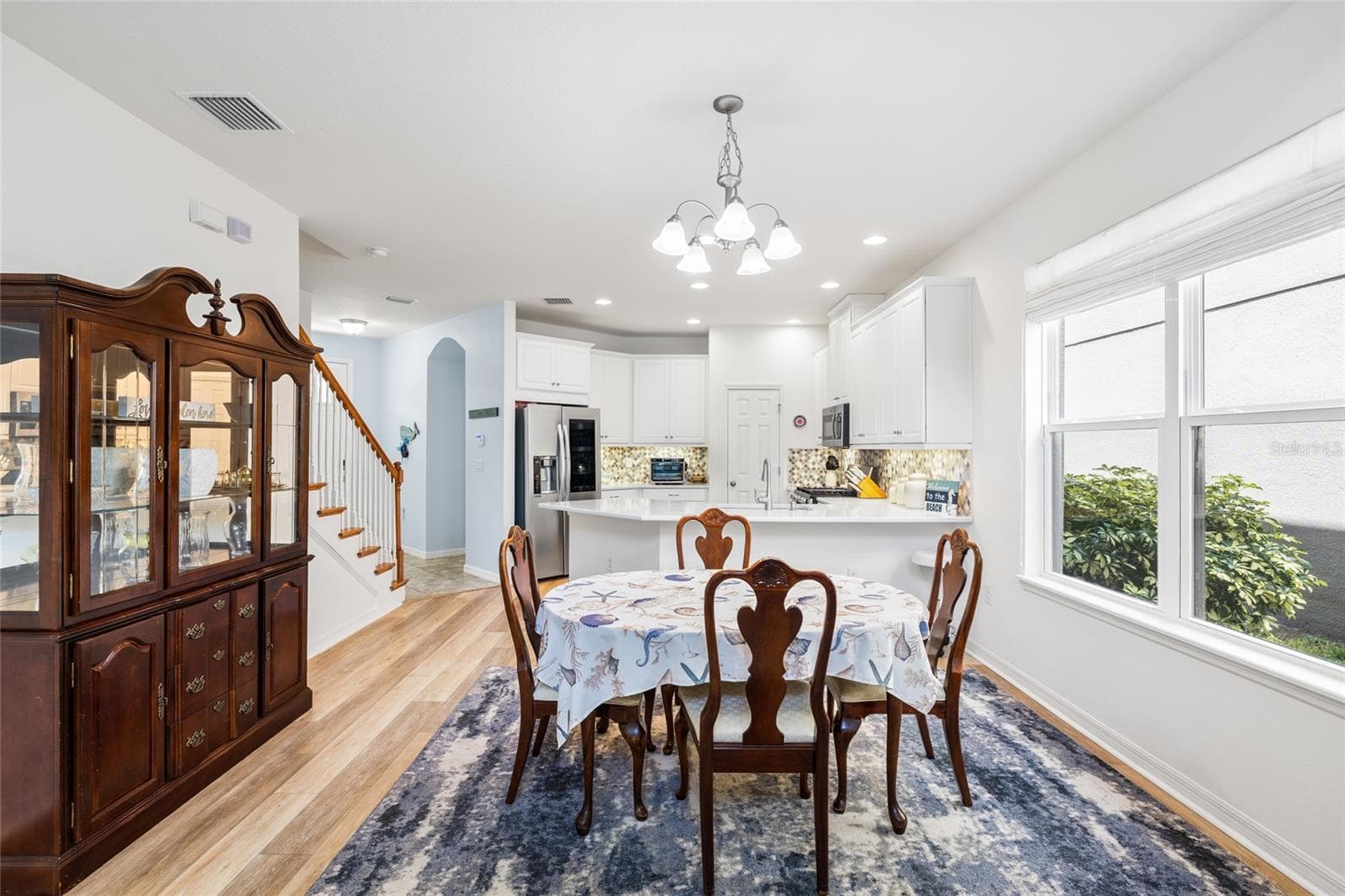 Dining area looking toward kitchen, entry way and garage (arched doorway) - 8519 ARABELLA LN, SEMINOLE