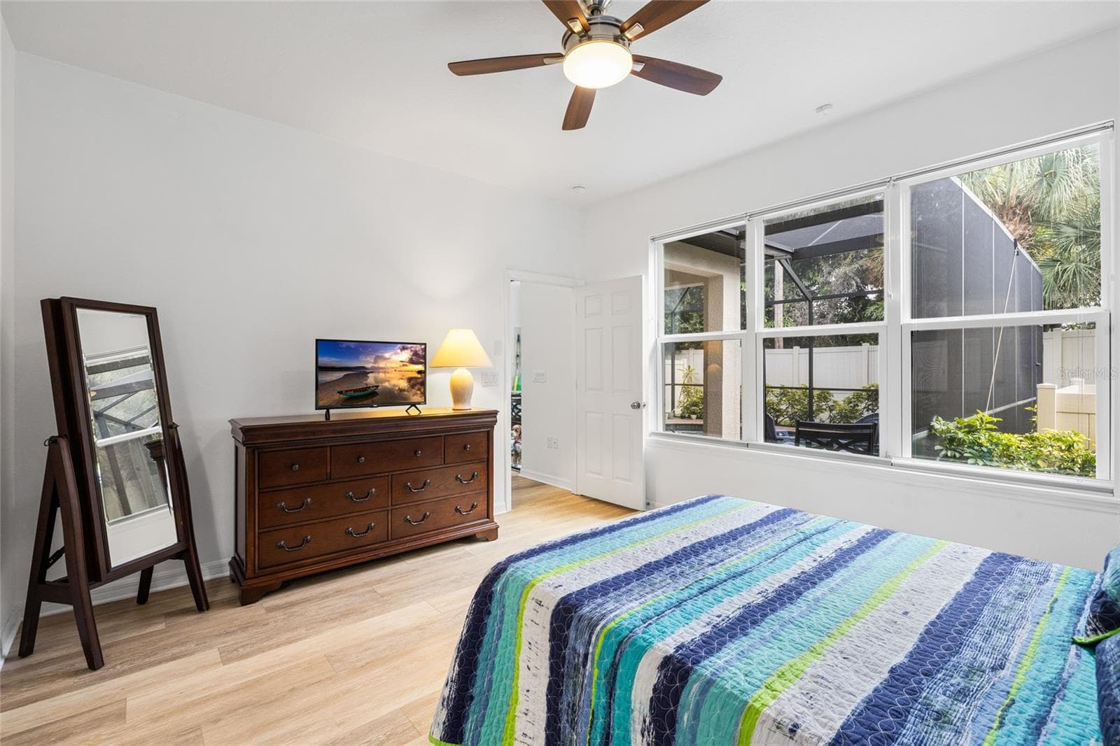 Primary suite - looking toward door to great room and pool area. - 8519 ARABELLA LN, SEMINOLE