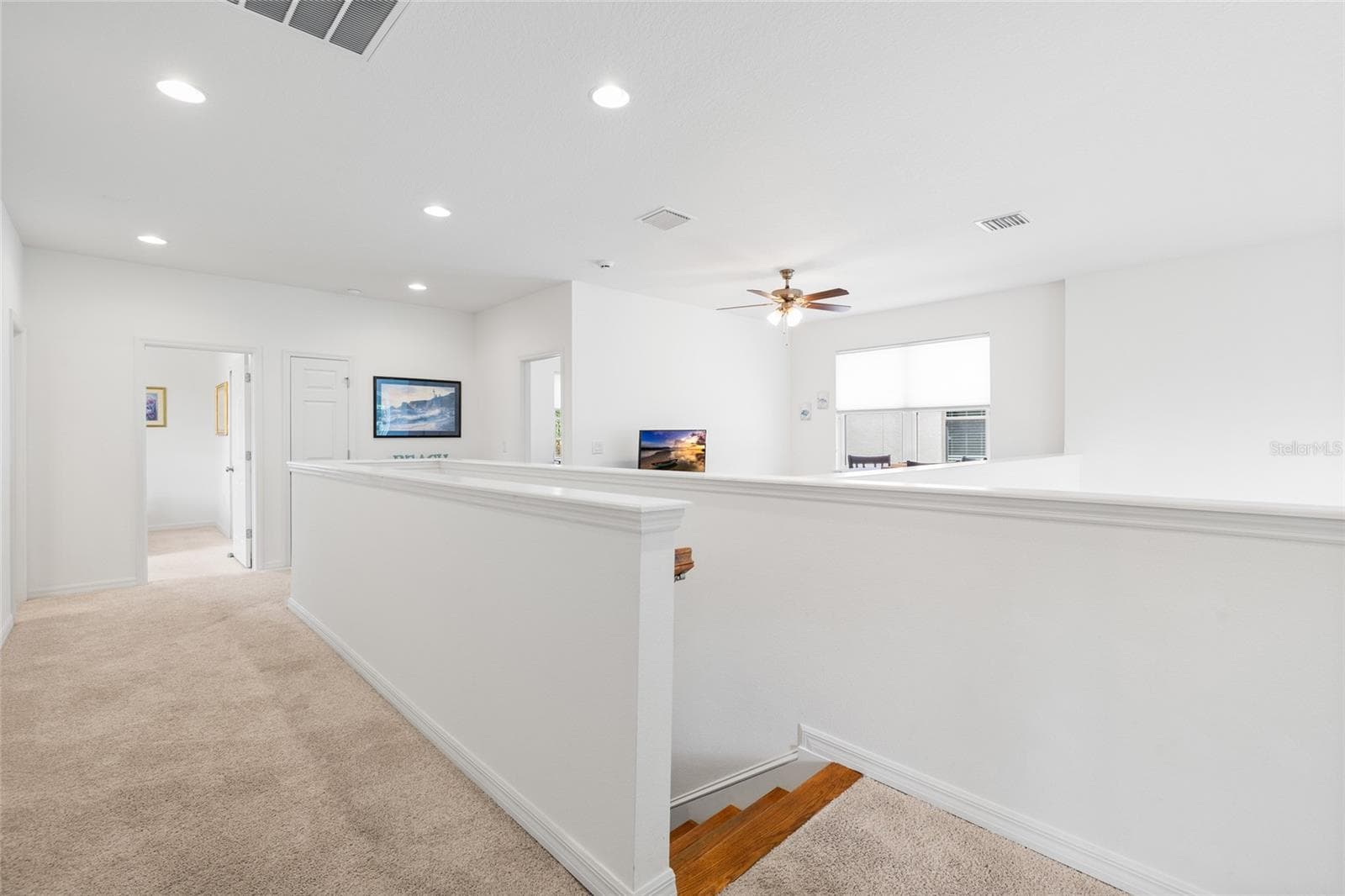 Upstairs hall area, going to stairs.  Open to below on right. - 8519 ARABELLA LN, SEMINOLE