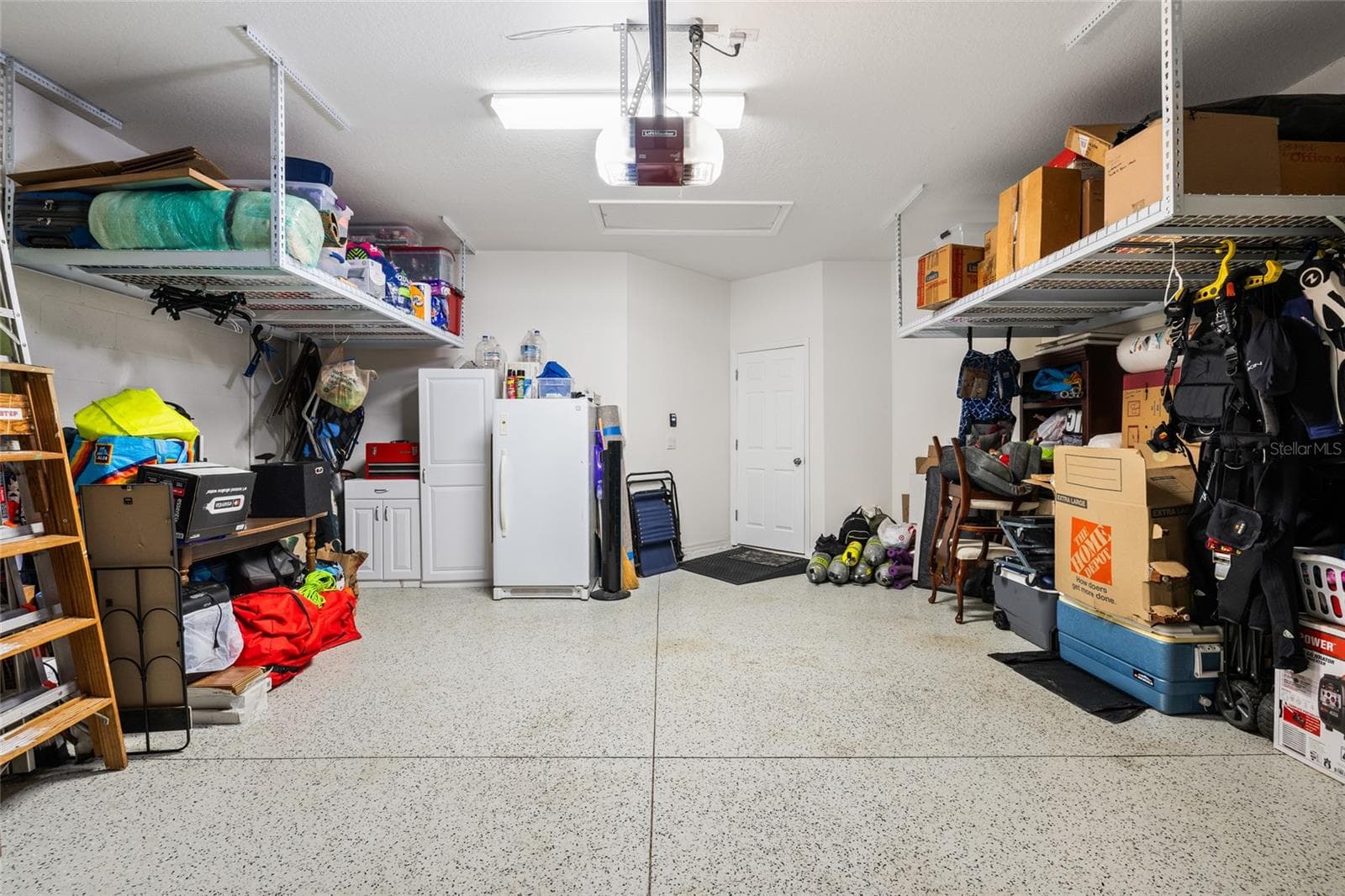 Spacious garage with finished floor and an abundance of storage. - 8519 ARABELLA LN, SEMINOLE