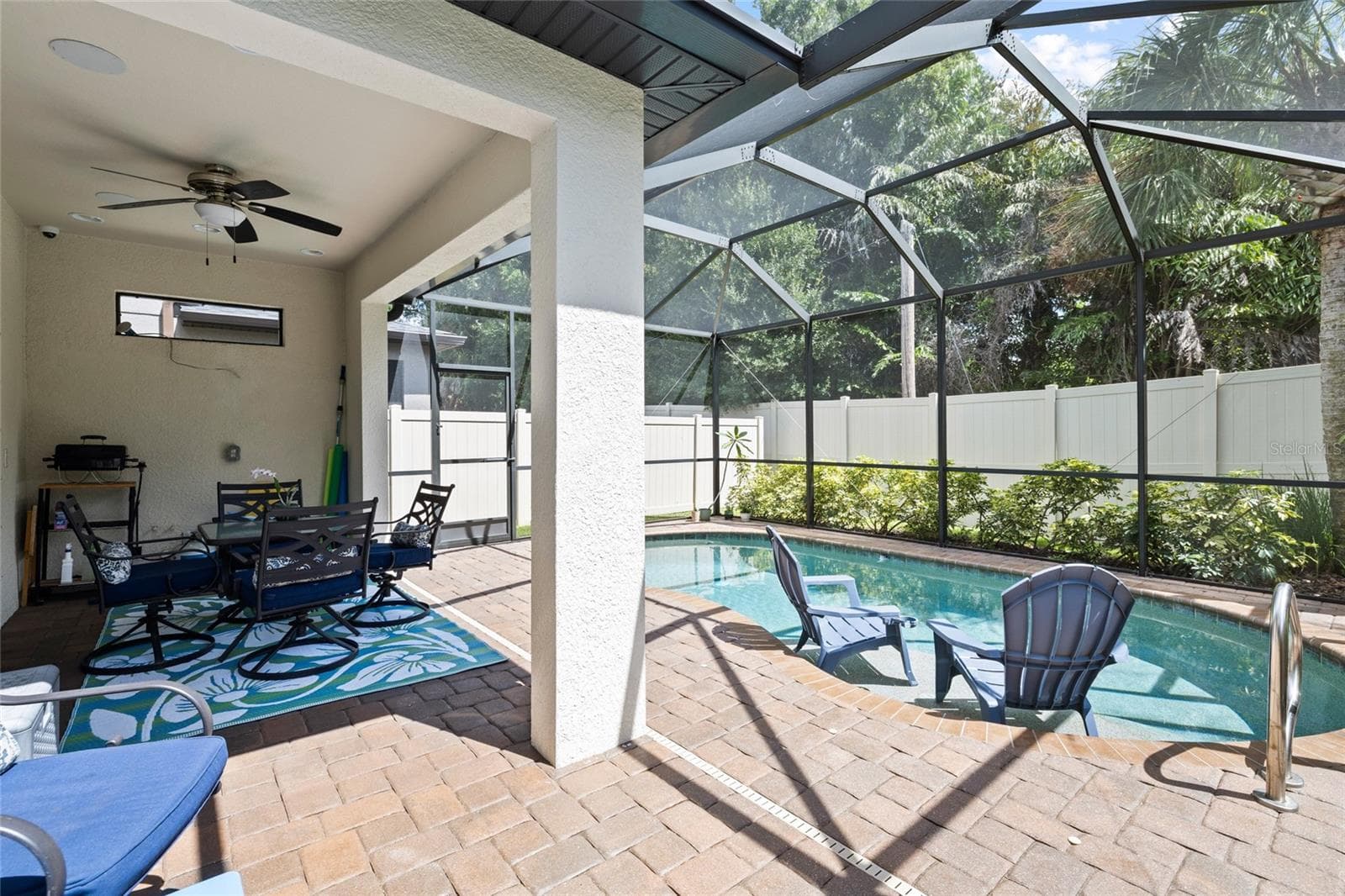 Pool area - salt water pool with "sunning bench". (Chairs are actually on the sunning bench so you can sit with your feet in the water. - 8519 ARABELLA LN, SEMINOLE