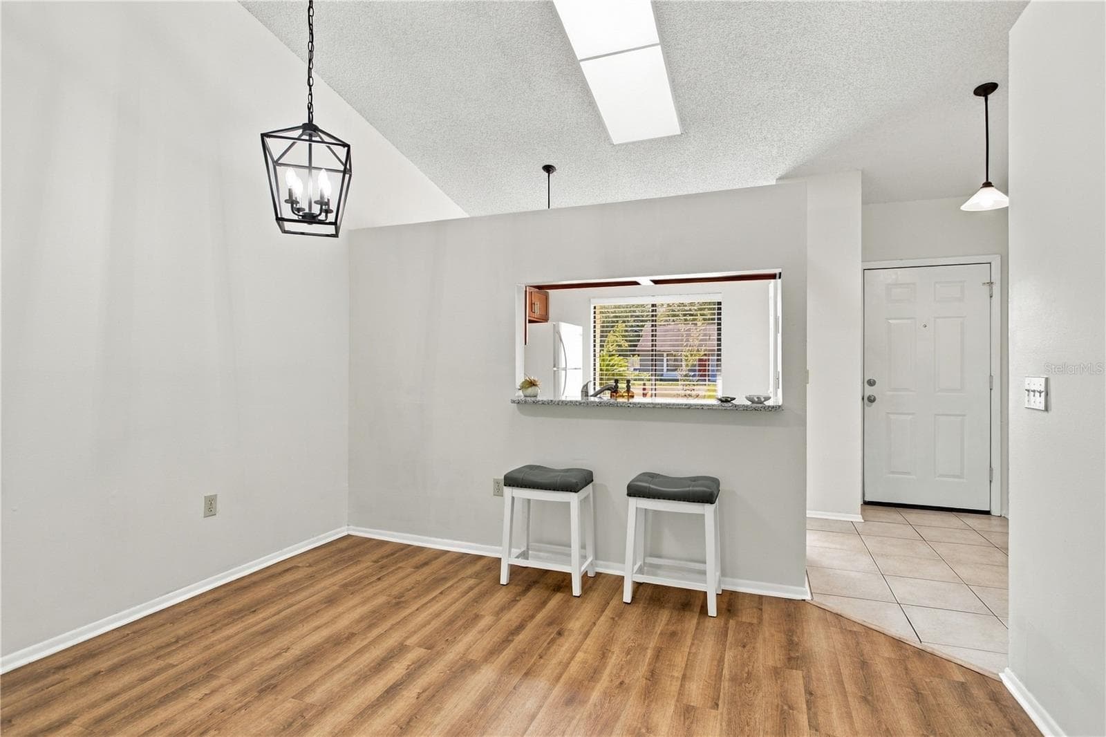 Dining area of Great Room with pass-through opening - 9911 LANCEWOOD ST, ORLANDO