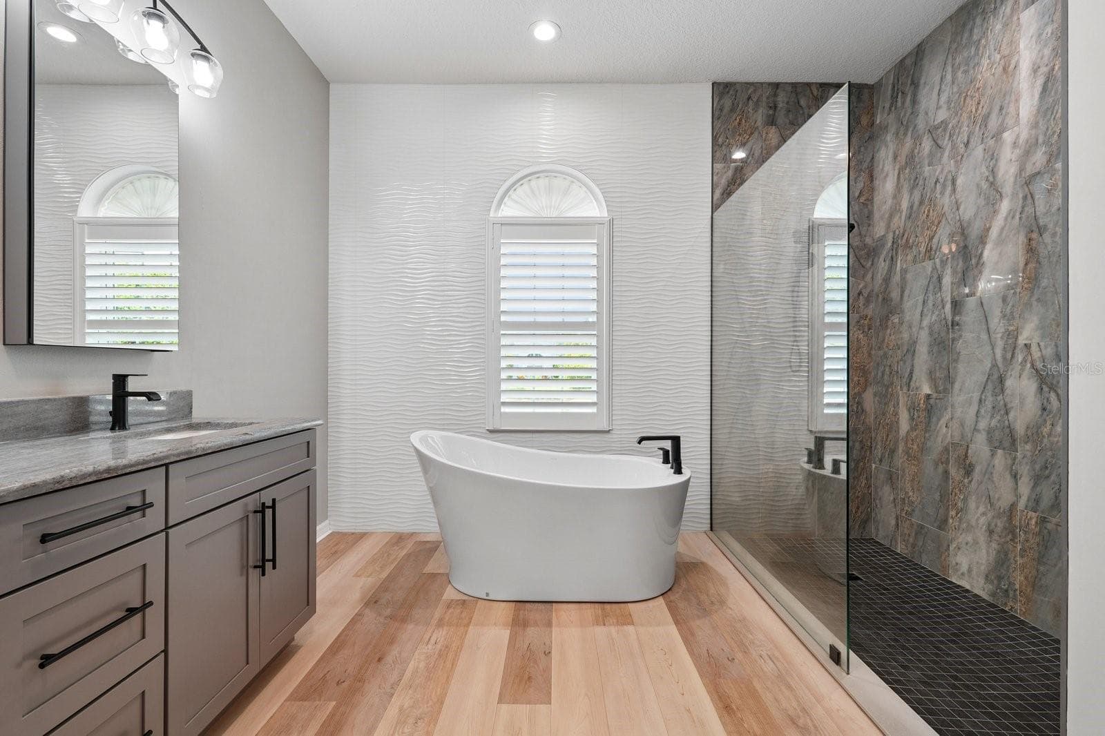 Renovated Primary Bath with Freestanding Tub and Accent Tile Wall - 1003 KINGS WAY LN, TARPON SPRINGS