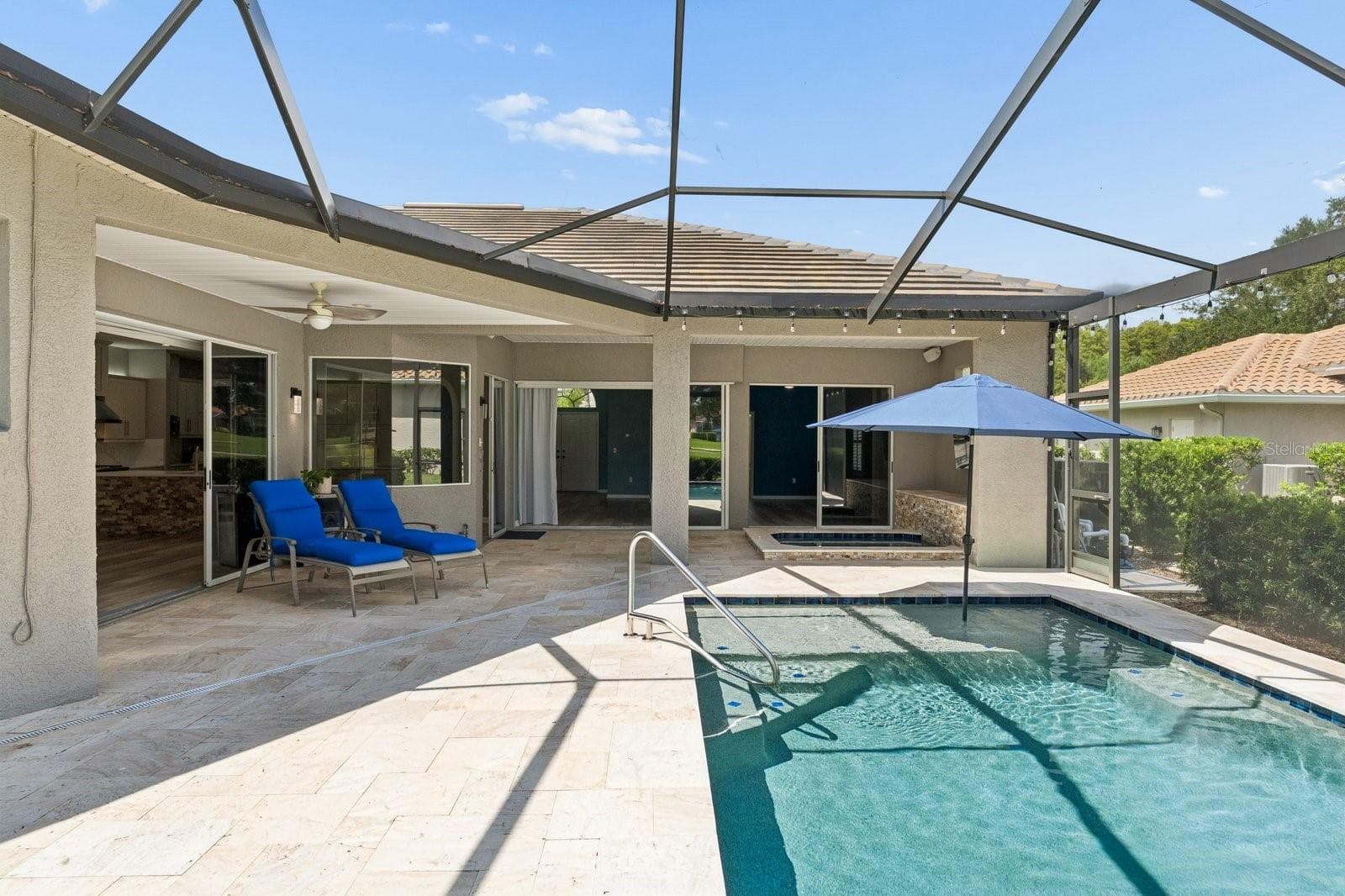 Pool Surrounded by Travertine Decking - 1003 KINGS WAY LN, TARPON SPRINGS