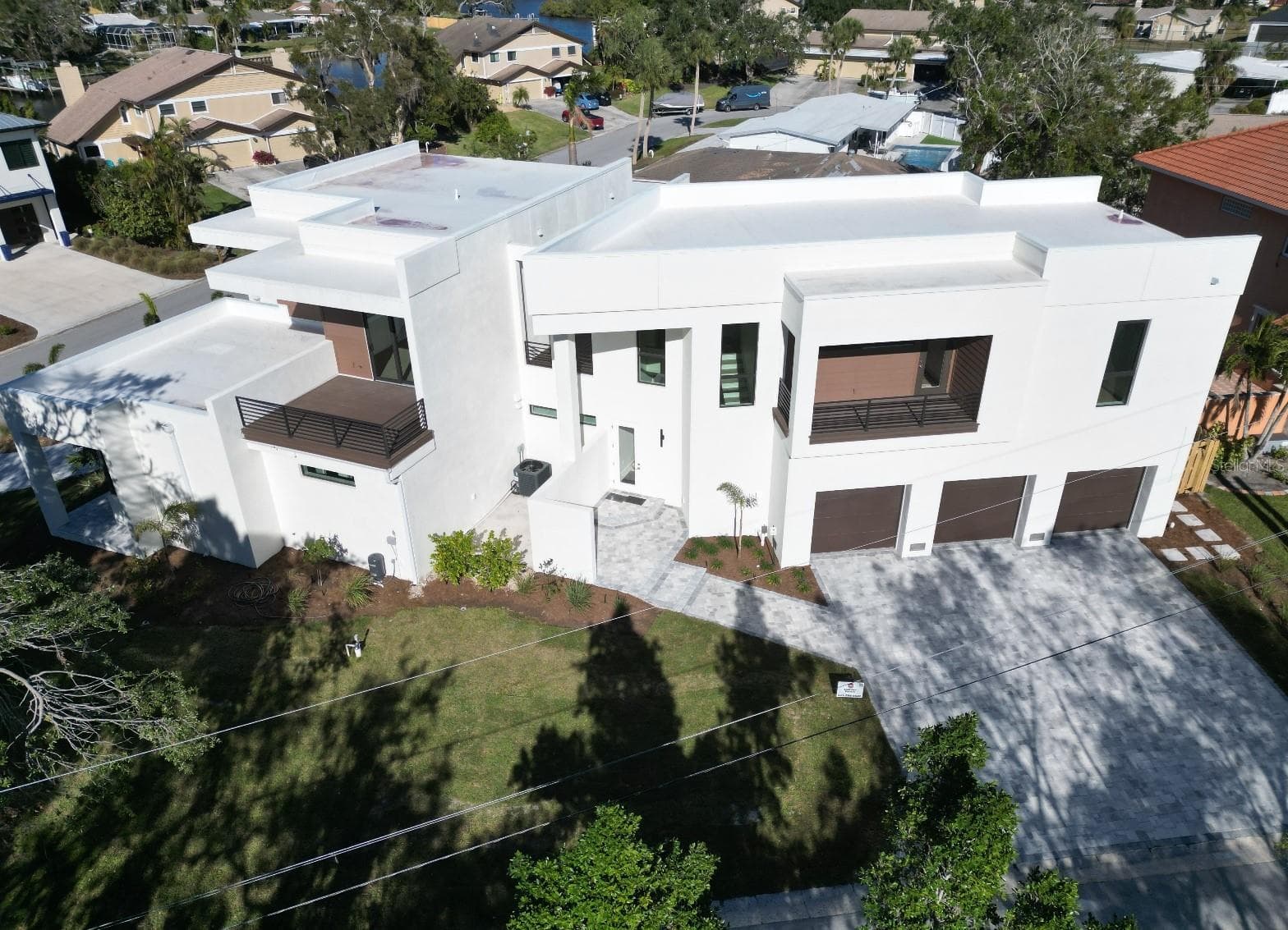 Two ensuite 2nd floor bedrooms have balconies; guest suite above garage has a kitchen, nook, bedroom, great room, laundry, and balcony. - 2110 MICHELE DR, SARASOTA