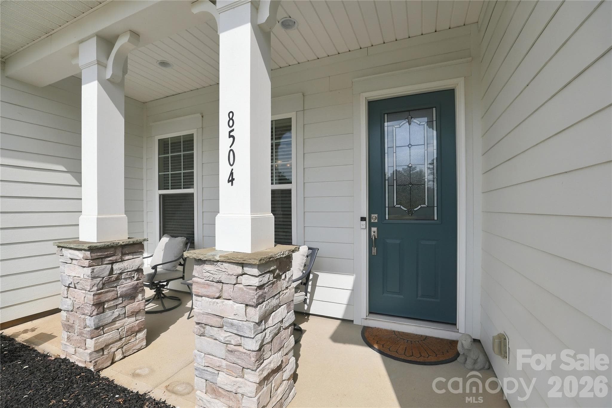 Welcoming entrance with a covered, rocking-chair front porch offers space to sit, relax and unwind. - 8504 Hope Run Court, Indian Land