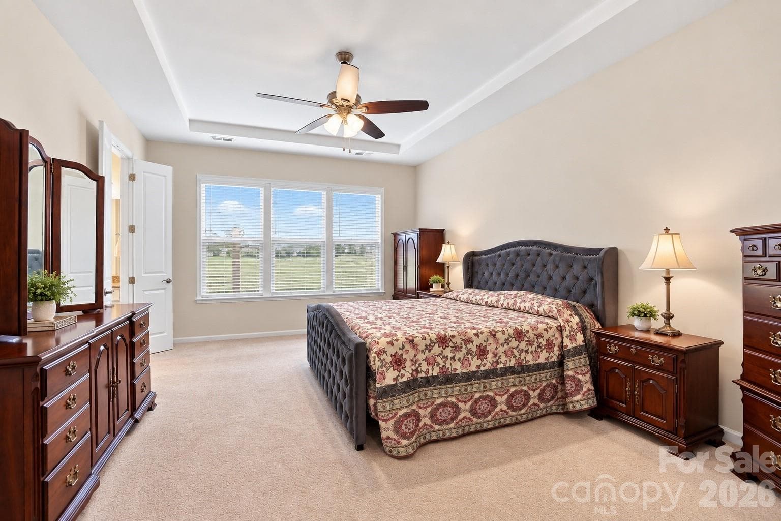 Spacious, main-level primary suite: comfortable place to retreat, relax, recharge at the end of the day. Room for sitting area, larger furniture pieces. - 8504 Hope Run Court, Indian Land
