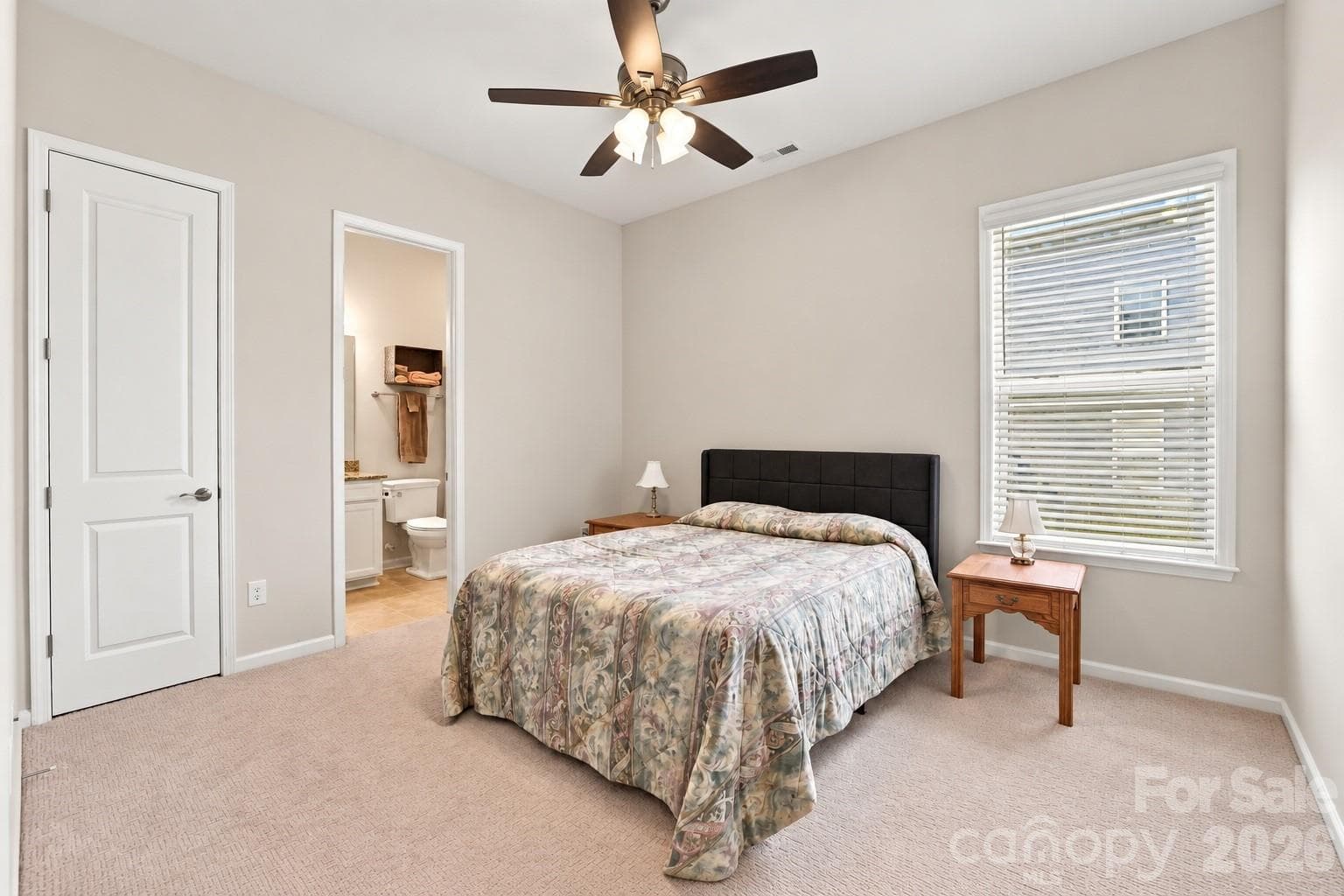 Bedroom with en-suite bath on main floor ideal for guests or family members who can't easily navigate stairs. - 8504 Hope Run Court, Indian Land
