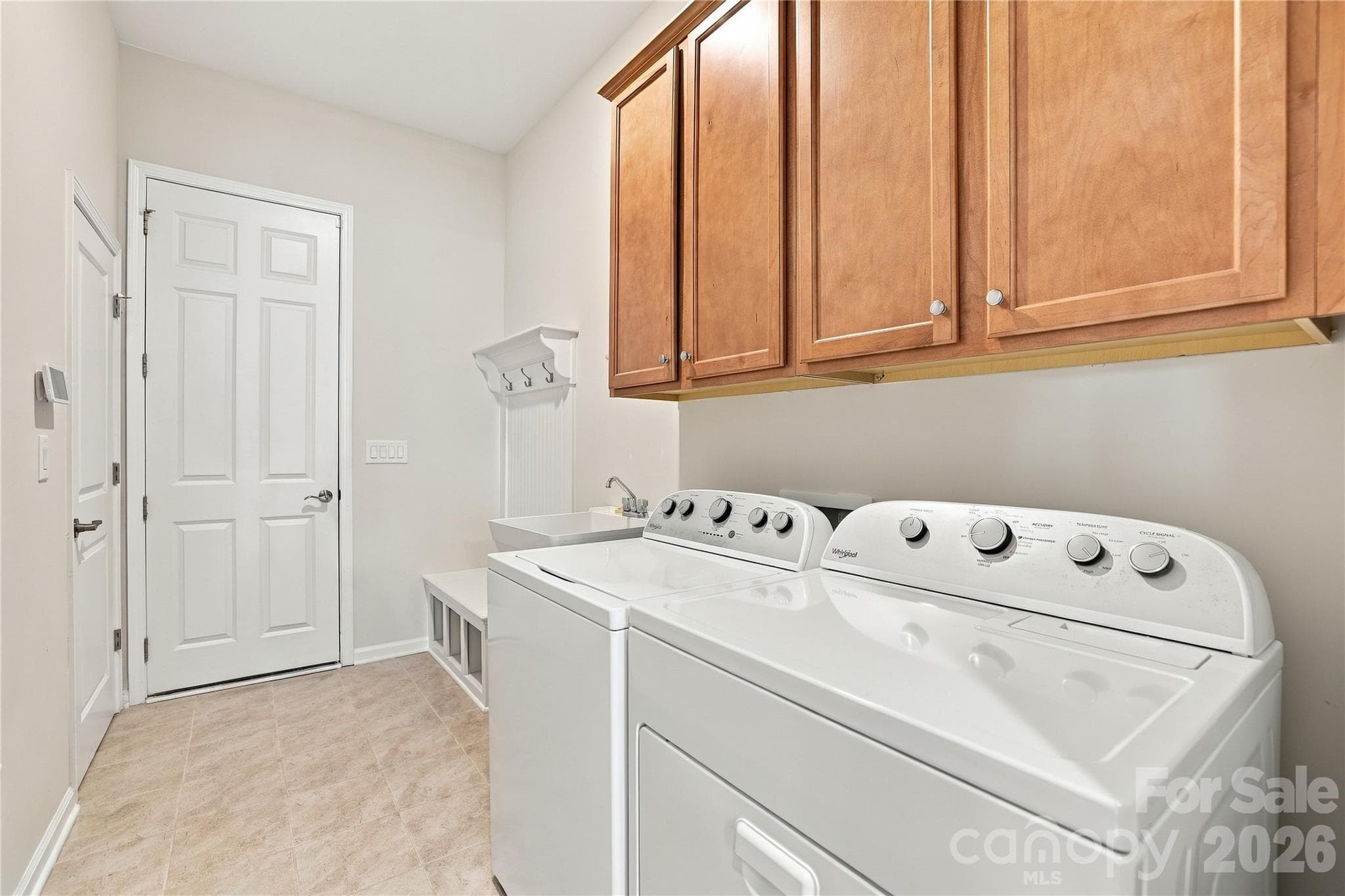 Drop zone/laundry room includes cabinet and shelf storage, a soaking tub, room for large washer/dryer. A utility closet adds additional storage space. - 8504 Hope Run Court, Indian Land