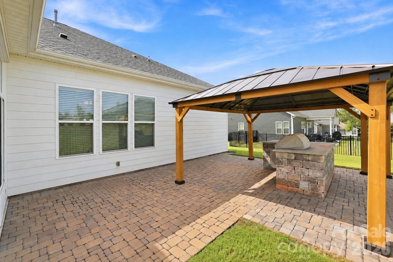 Patio area with built-in grilling center, custom gazebo, brick pavers extend the home's living and entertaining space. - 8504 Hope Run Court, Indian Land