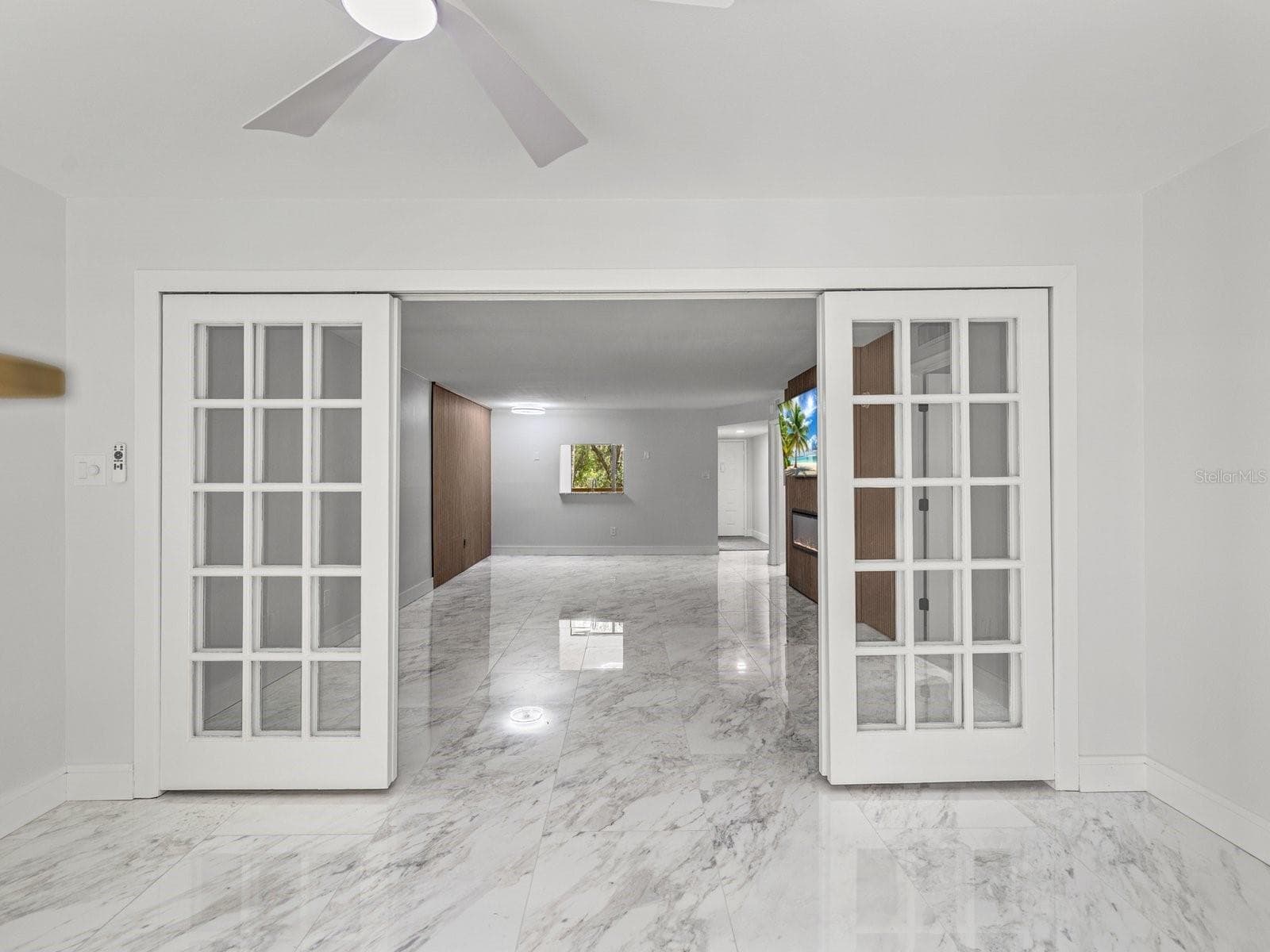 Bonus room in front of screen patio has sliding French doors - 3076 EASTLAND BLVD #203, CLEARWATER