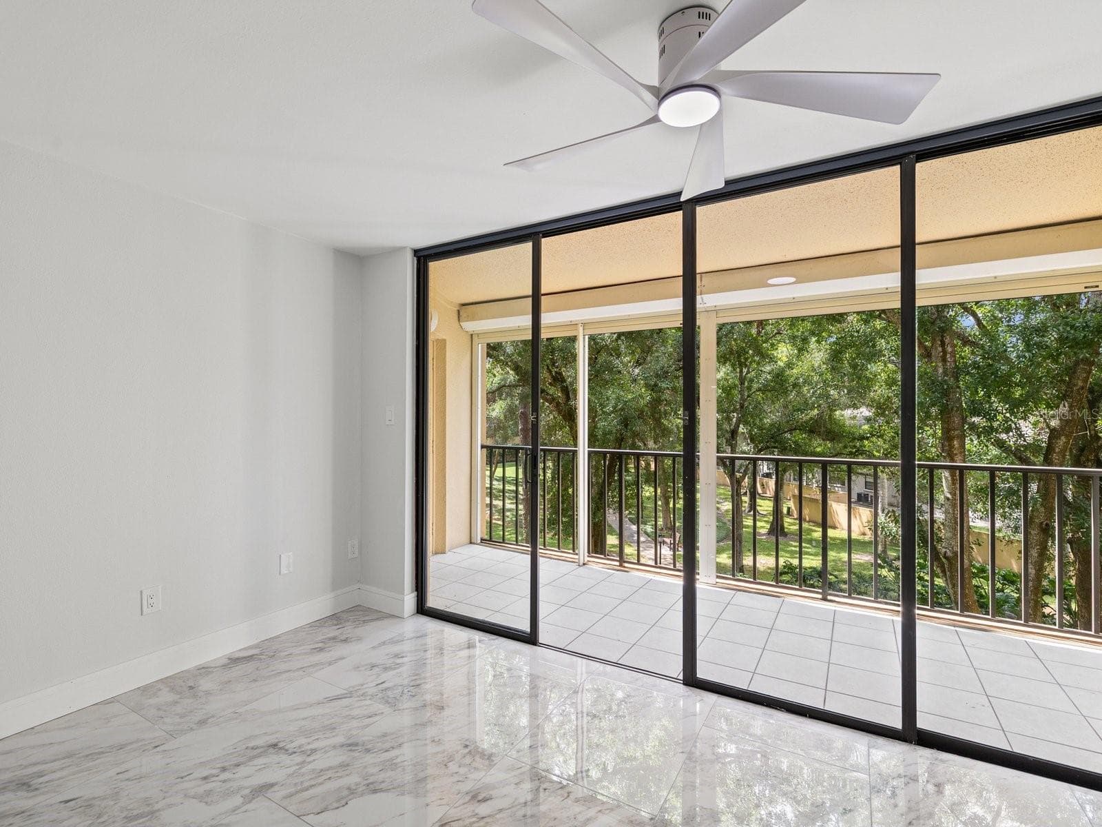 Sliding doors to screen patio space with hurricane shutters for peace of mind - 3076 EASTLAND BLVD #203, CLEARWATER
