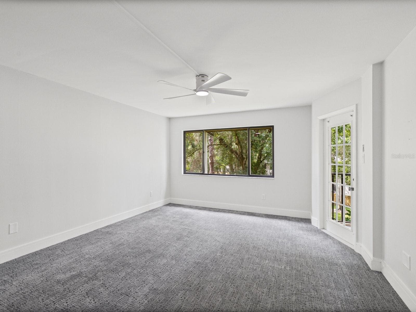 Primary bedroom with entry to patio - 3076 EASTLAND BLVD #203, CLEARWATER