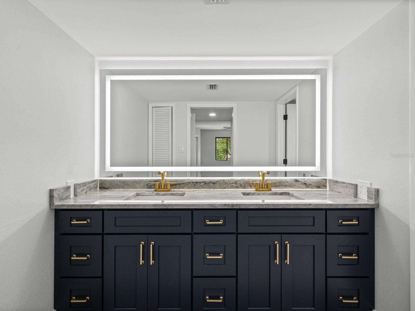 Primary bath with NEW double sink tall vanity and touch light mirror - 3076 EASTLAND BLVD #203, CLEARWATER