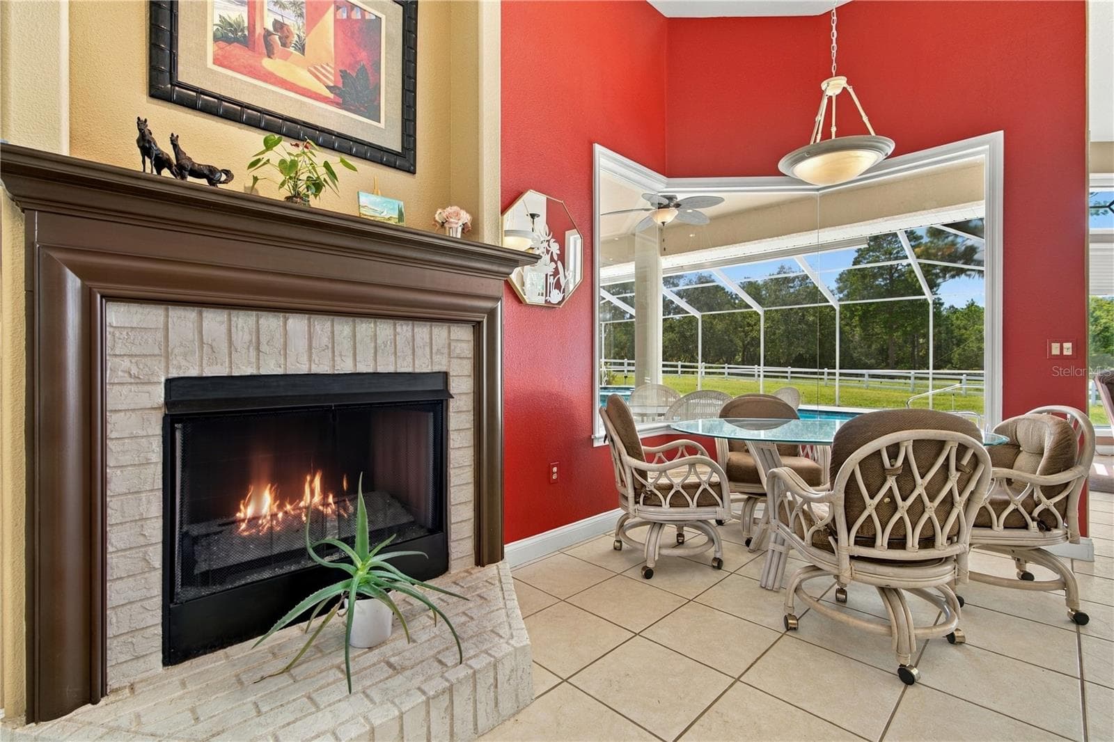 Cozy fireplace creates an inviting spot to unwind in the breakfast area while watching the horses - 6722 W SENTINEL BLUFF PATH, BEVERLY HILLS