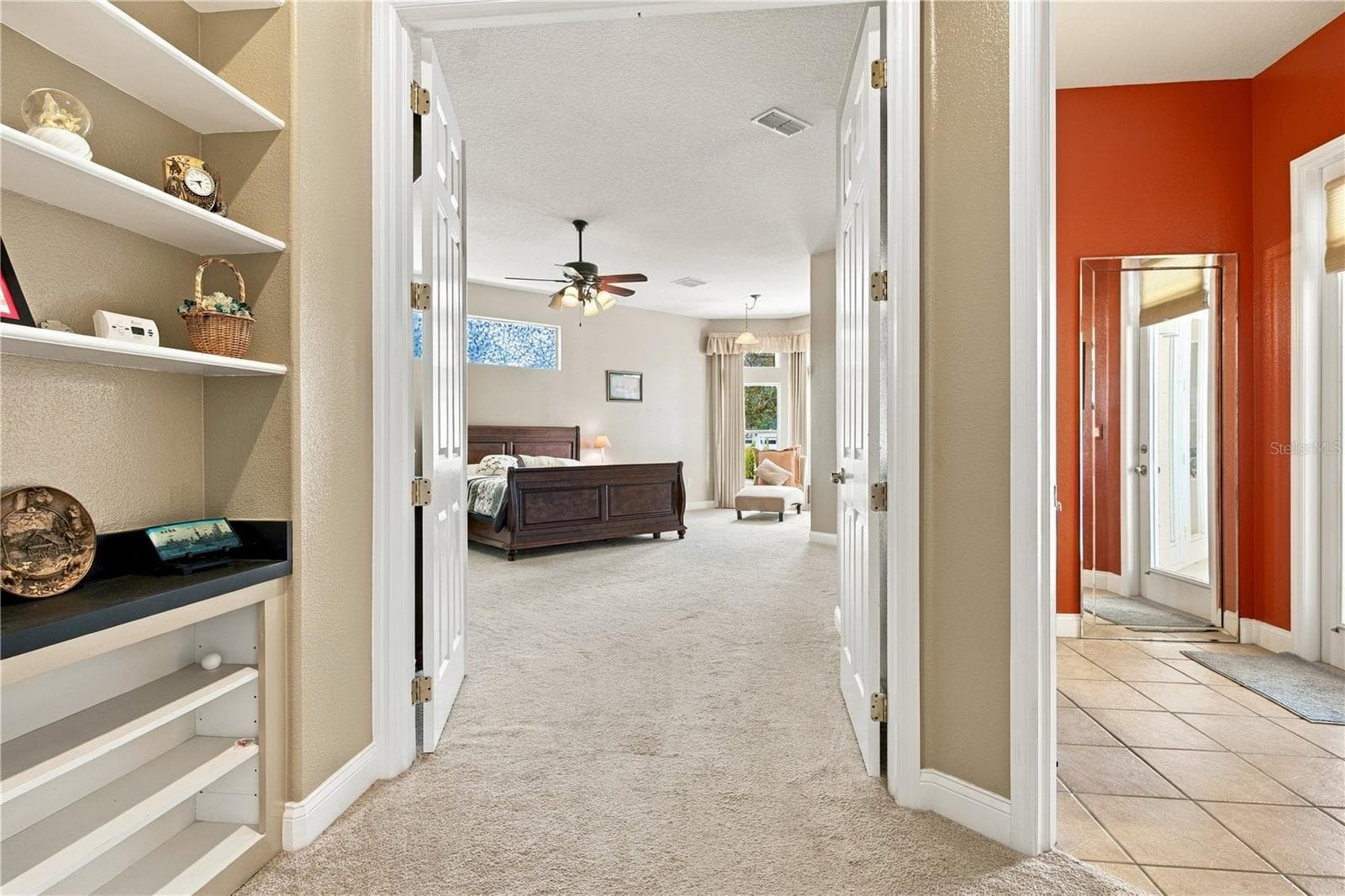 Beautiful built in cabinetry provides attractive display and storage space in the entry to the primary bedroom - 6722 W SENTINEL BLUFF PATH, BEVERLY HILLS