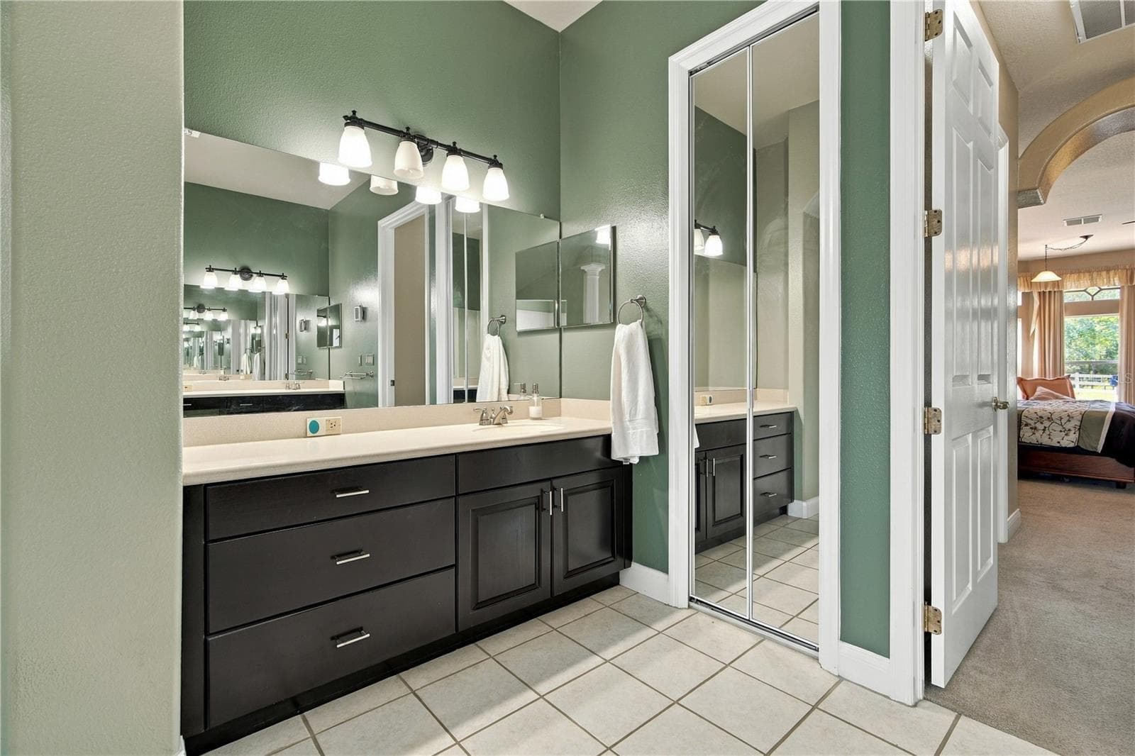 Expansive primary bath with abundant cabinetry and generous vanity space. - 6722 W SENTINEL BLUFF PATH, BEVERLY HILLS