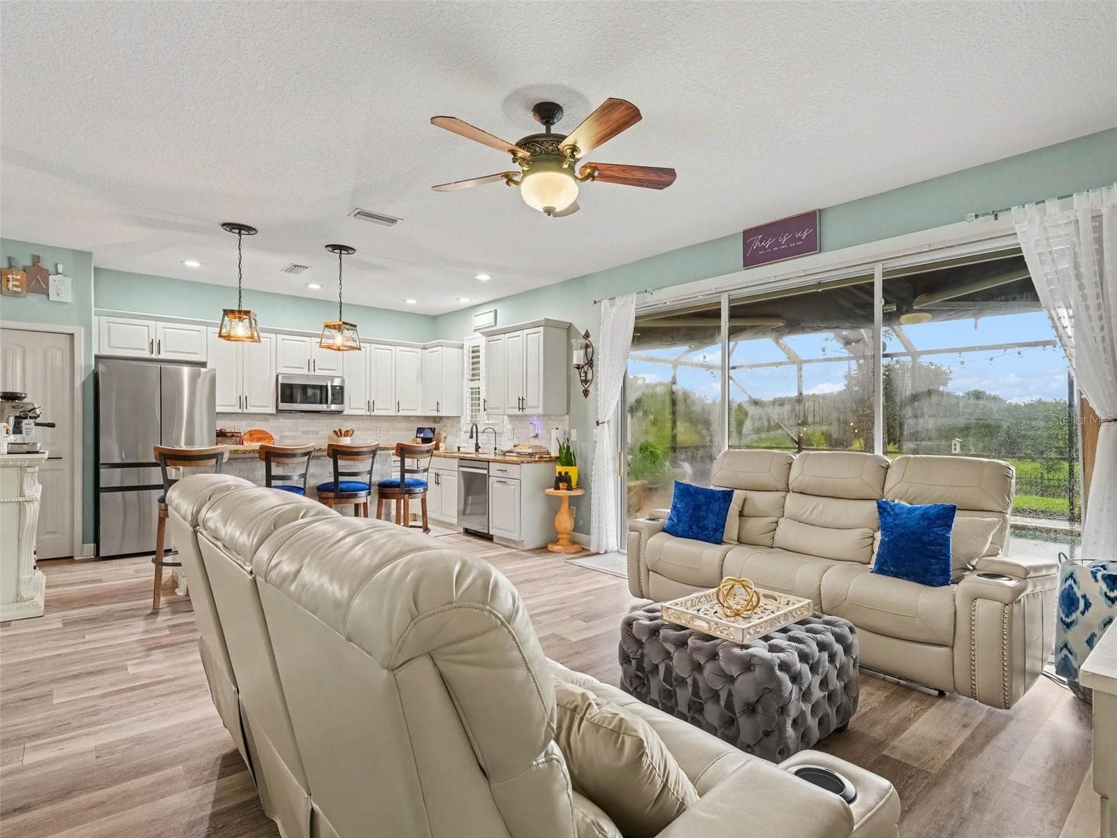 Living Room looking to the Kitchen and Enclosed Pool area - 7124 34TH ST E, SARASOTA