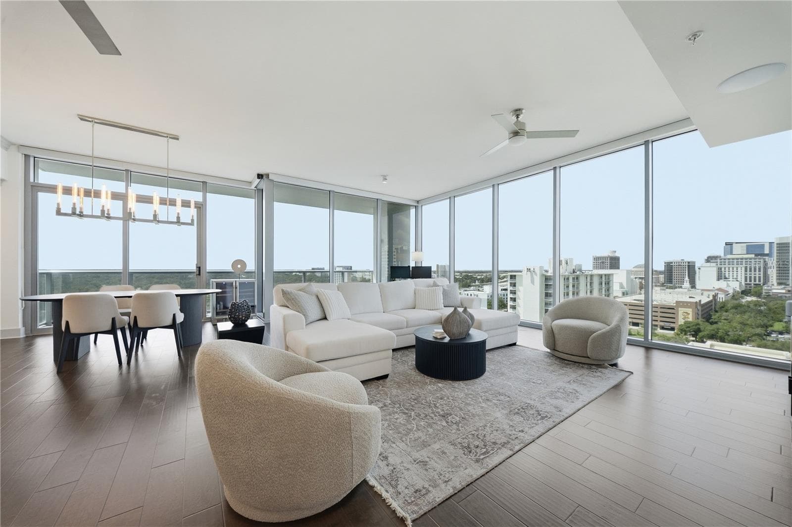 14th-Floor Corner Residence | Living and dining wrapped in 10-Foot Floor-to-Ceiling glass - 260 S OSCEOLA AVE #1406, ORLANDO