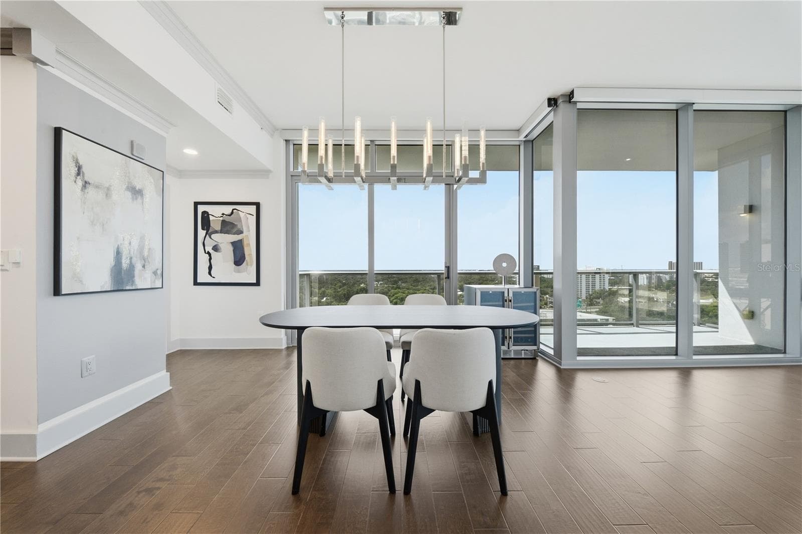 Dining + Kitchen | An open entertaining layout with the south-facing balcony just beyond - 260 S OSCEOLA AVE #1406, ORLANDO