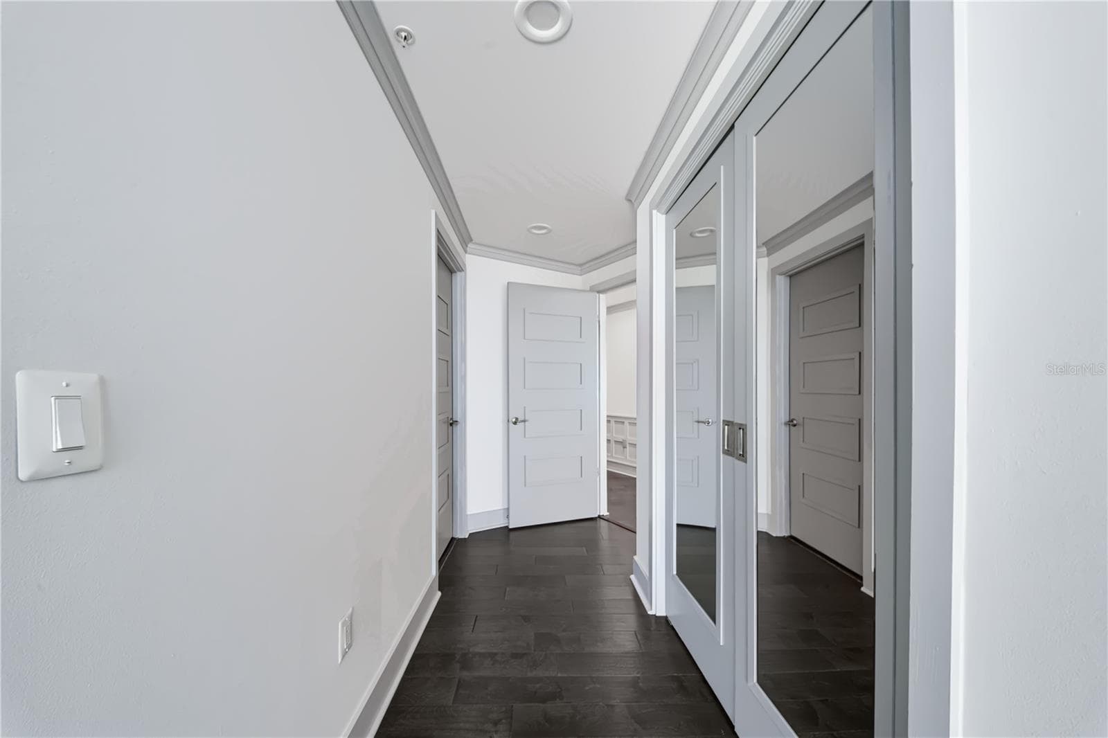 PRIMARY BEDROOM HALL / SECOND CLOSET. Mirror covered double doors has second closet in bedroom hall. - 260 S OSCEOLA AVE #1406, ORLANDO