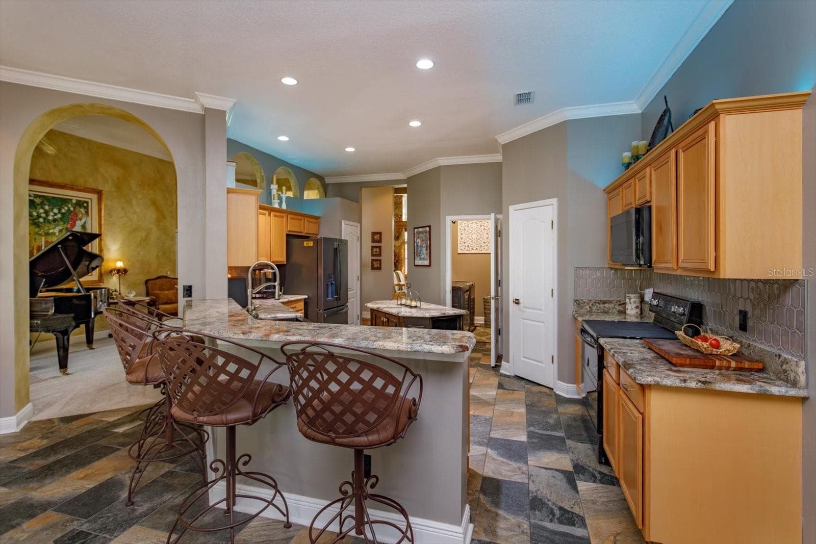 Kitchen updated with rich granite countertops and slate look tile flooring - 536 AVON GLADE PL, SANFORD