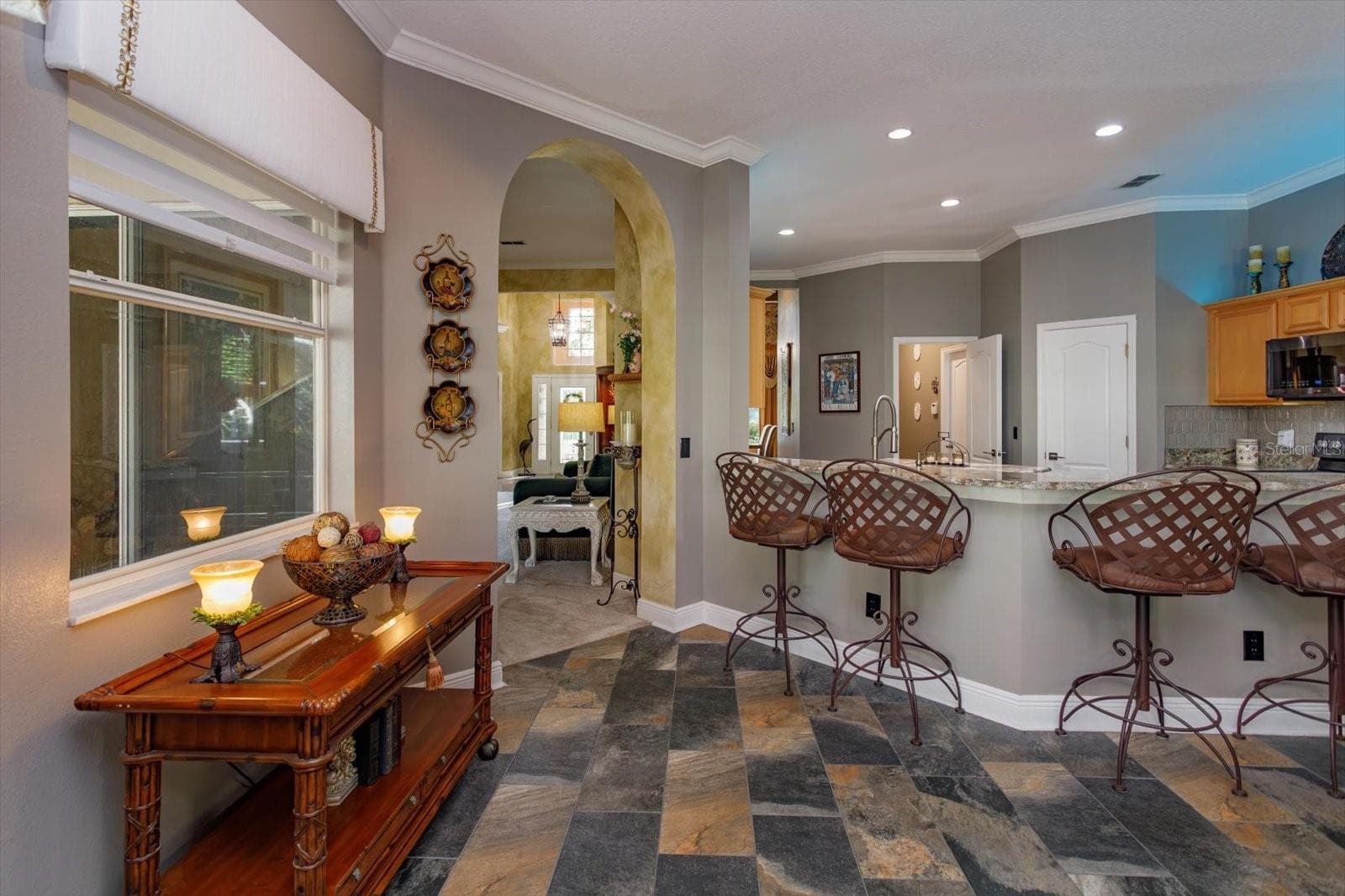 breakfast nook with view onto covered lanai and open to kitchen and family room - 536 AVON GLADE PL, SANFORD