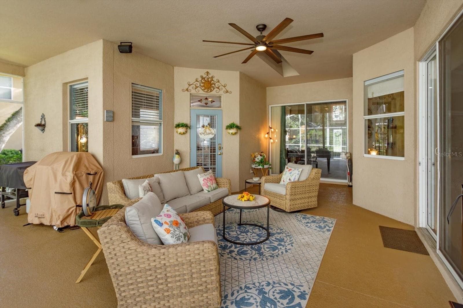 covered lanai open to living room, family room, and primary suite - 536 AVON GLADE PL, SANFORD