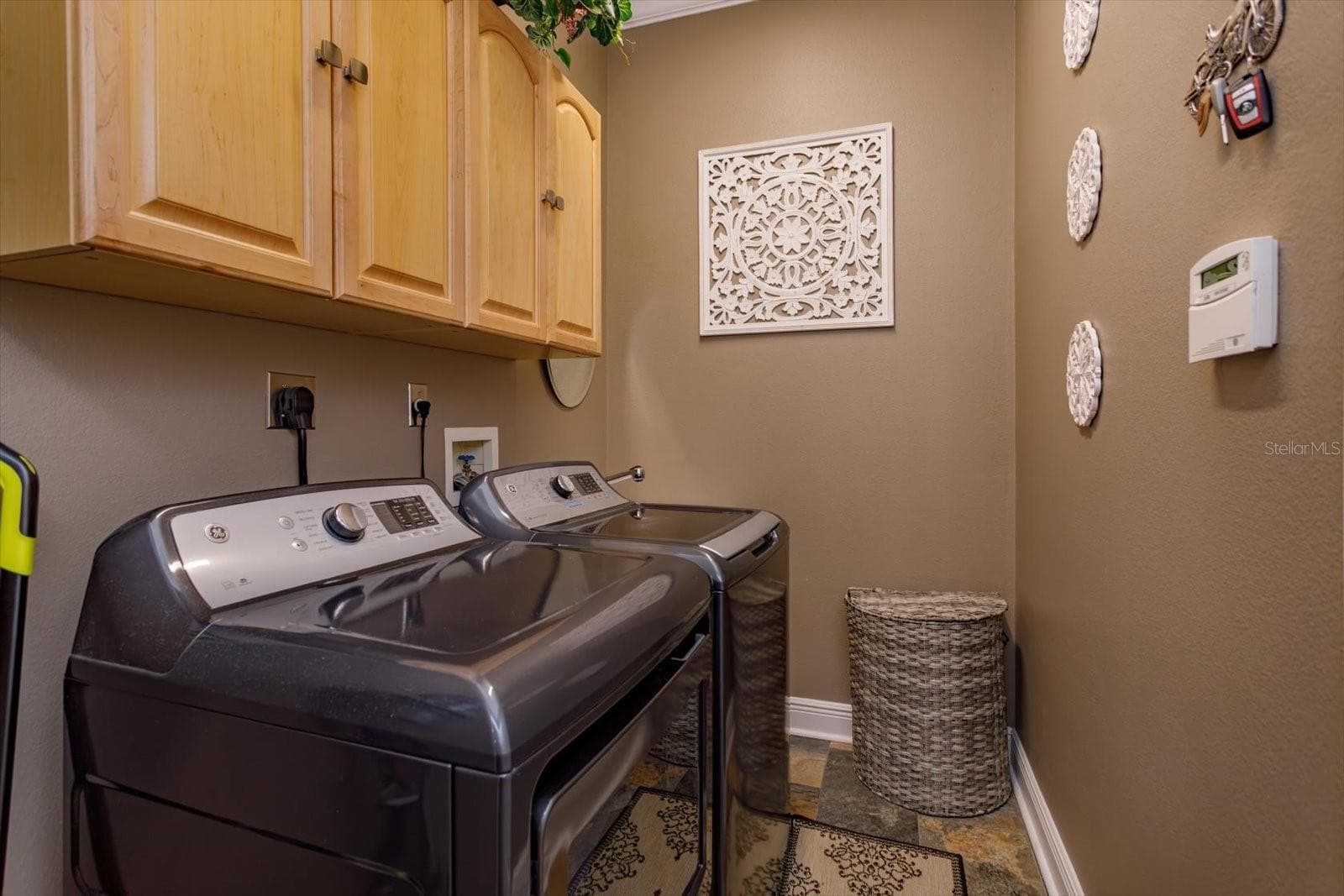 Laundry room has built-in utility sink and overhead cabinets - 536 AVON GLADE PL, SANFORD