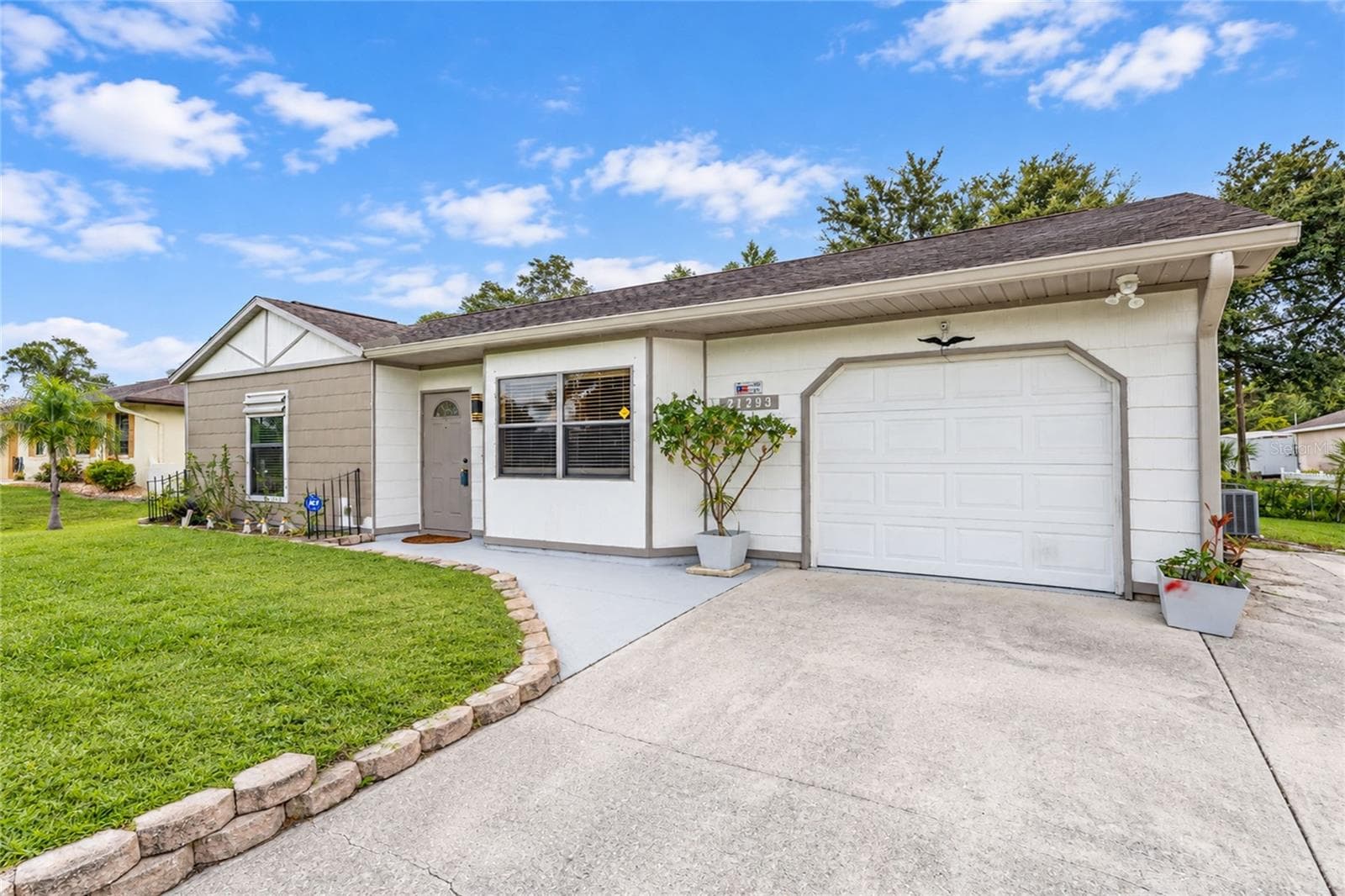 Front elevation with concrete side-skirting for additional parking. - 21293 PEMBERTON AVENUE, PORT CHARLOTTE