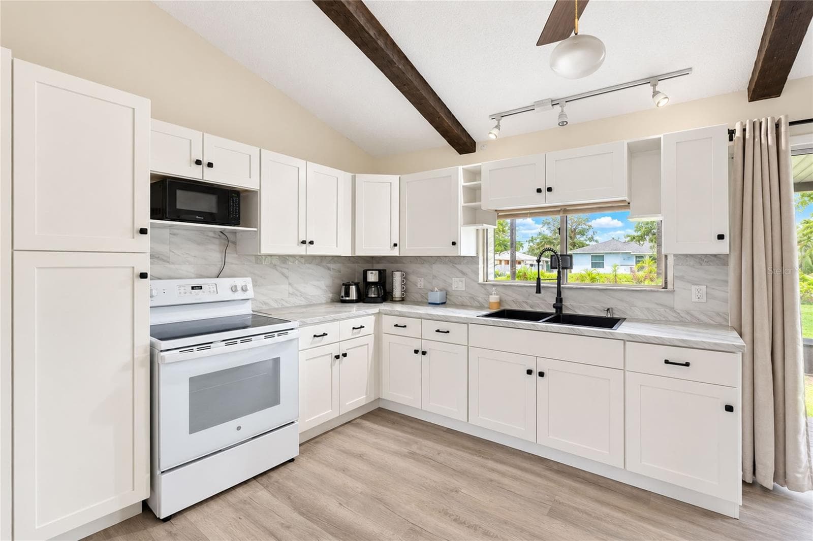 Kitchen with pass-through to the screened porch. - 21293 PEMBERTON AVENUE, PORT CHARLOTTE
