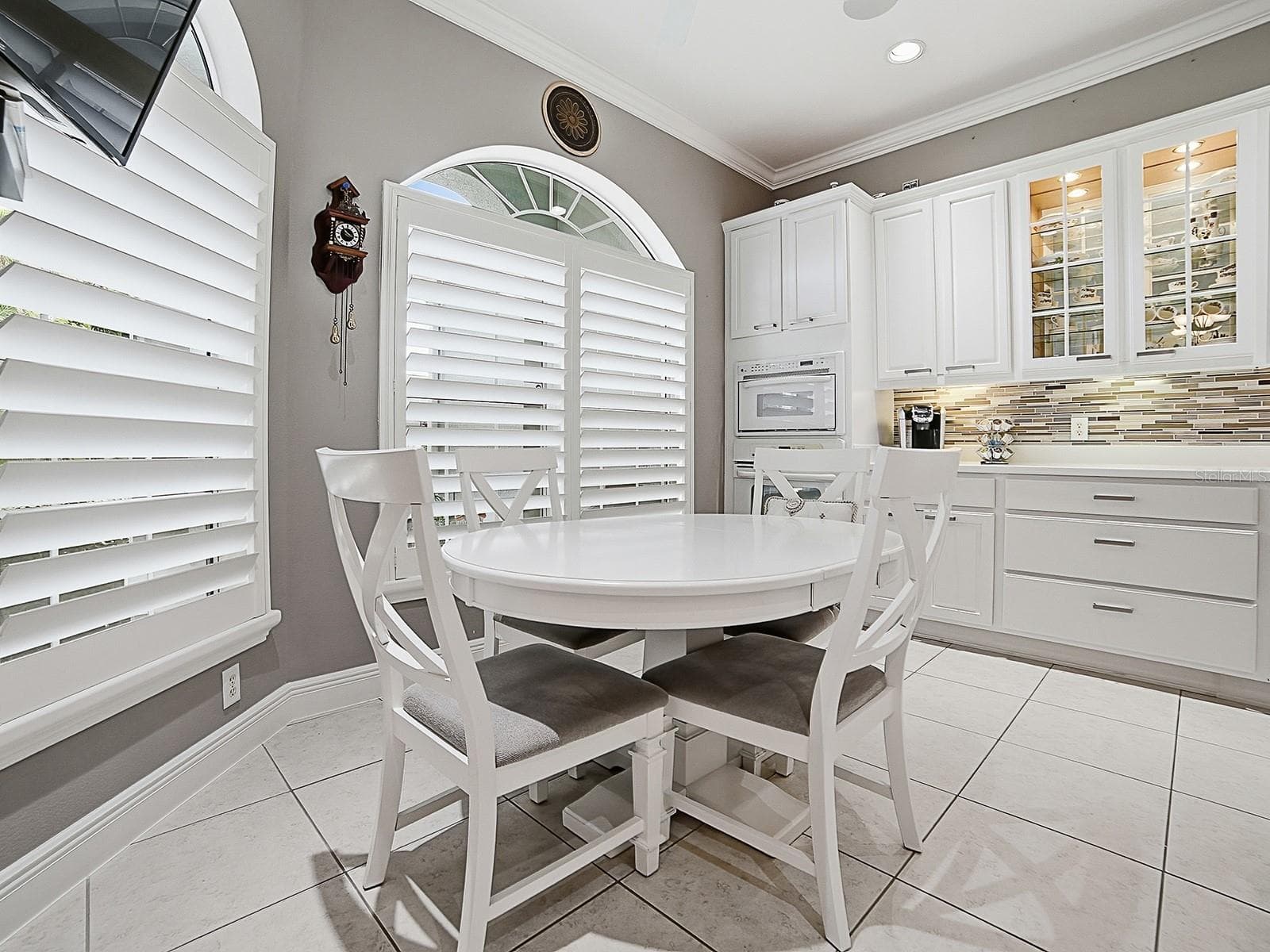 YOU'LL LOVE ALL THE COUNTER SPACE AND STORAGE, WALL OVENS, POT DRAWERS, GLASS INSERTS IN CABINETS, TILED BACKSPLASH, AND UNDER COUNTER LIGHTING. - 1897 HARTFORD PATH, THE VILLAGES