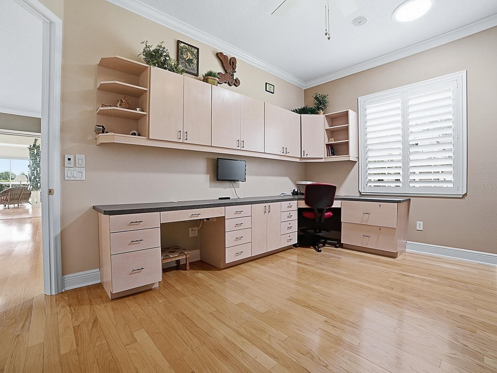 THE 2ND GUEST ROOM HAS A CUSTOM DOOR THAT OPENS OUT TO THE LIVING AREA, A SOLAR TUBE, CUSTOM CABINETS AND BUILT-IN DESK, AND A MURPHY BED. - 1897 HARTFORD PATH, THE VILLAGES