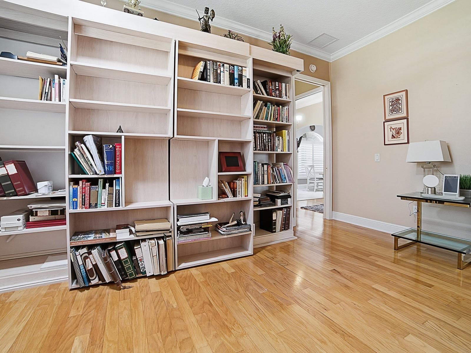 SLIDE THE BOOK SHELVES TO EITHER SIDE TO ACCESS THE MURPHY BED. - 1897 HARTFORD PATH, THE VILLAGES