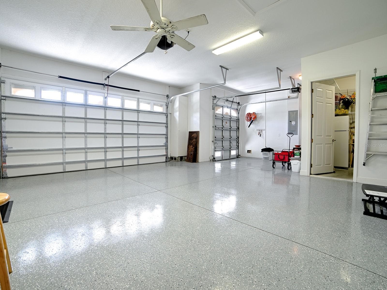 PLENTY OF ROOM IN THIS 824 SQ. FT. GARAGE WITH EPOXY FLOORING, AND A CUSTOM AIR CONDITIONED STORAGE ROOM. - 1897 HARTFORD PATH, THE VILLAGES