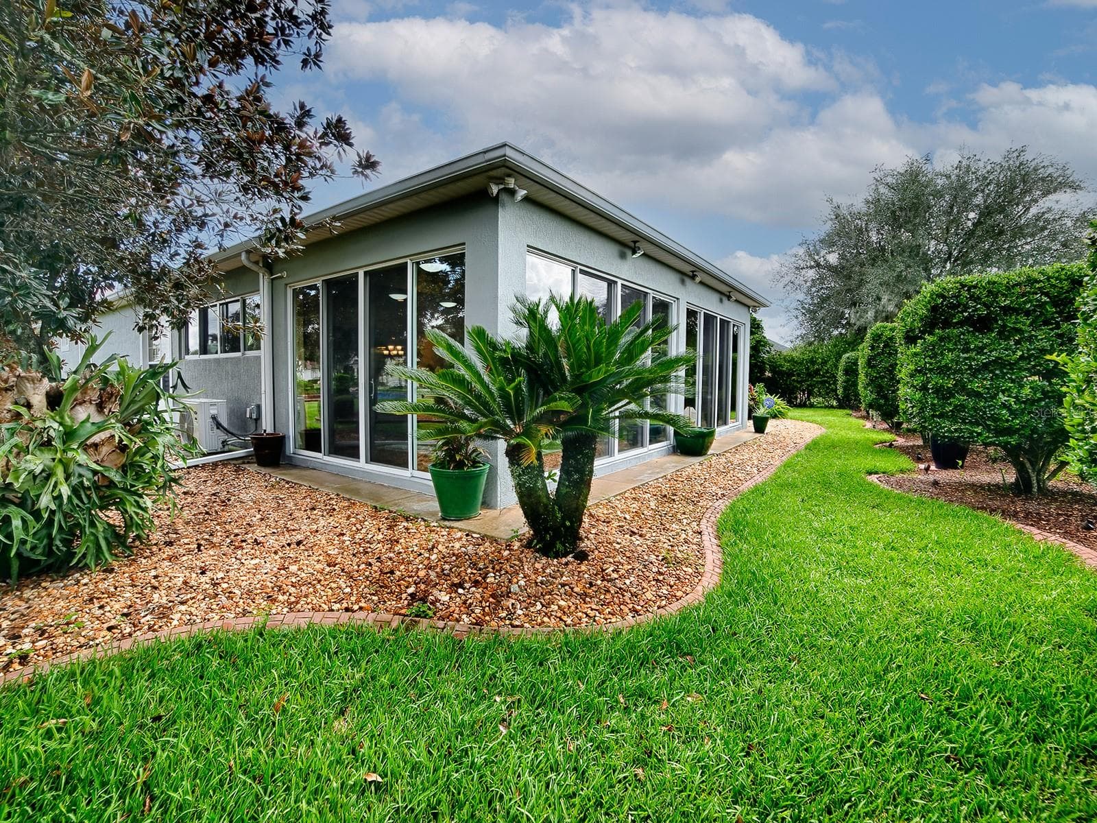 THE BACK OF THE HOME - LOVELY LANDSCAPING WITH CURBING AND ROCK BEDS. - 1897 HARTFORD PATH, THE VILLAGES