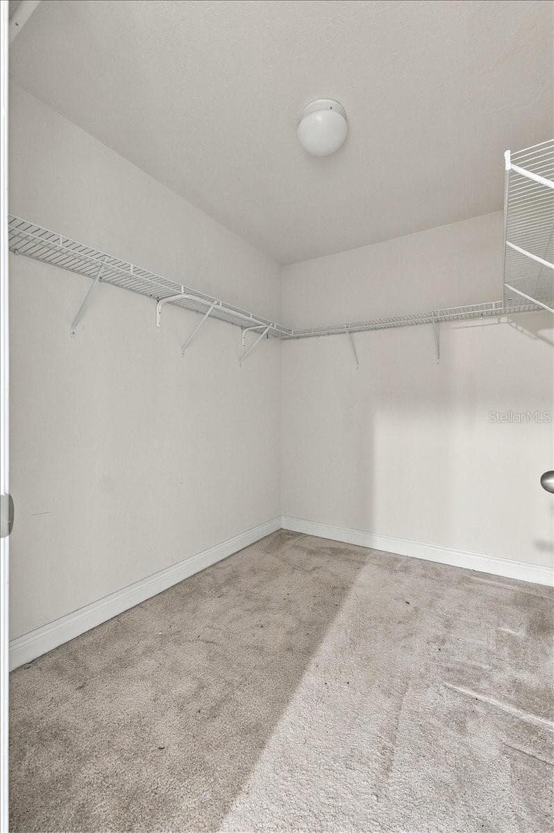 Spacious walk-in closet with built-in shelving - 7560 ALOMA PINES CT, WINTER PARK