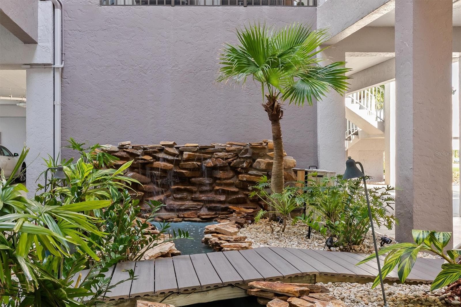 Step bridge from parking to elevator over fountain - 1600 W MARION AVE #224, PUNTA GORDA