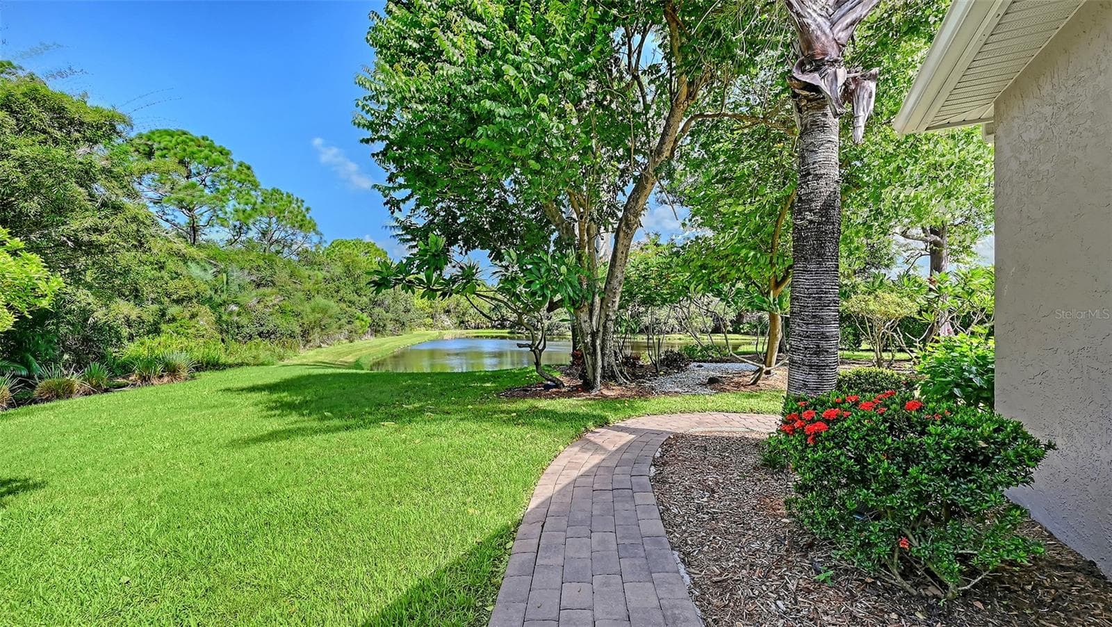 View of the lake from the screened pool area. - 8866 BLOOMFIELD BLVD, SARASOTA