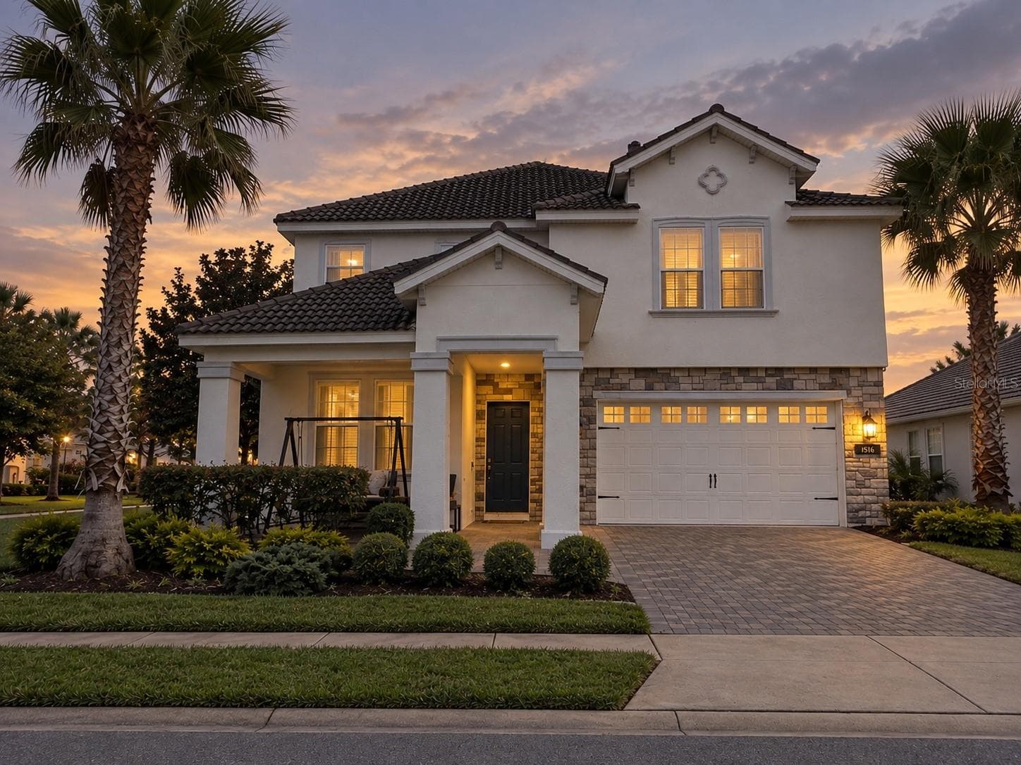 Twilight view highlighting the home's welcoming exterior and architectural details. - 1516 BUNKER DR, DAVENPORT