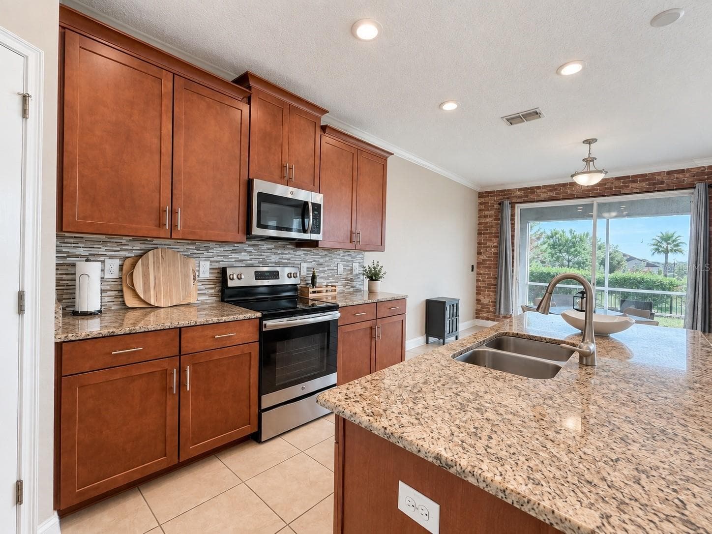 Spacious kitchen with plenty of cabinetry, generous counter space and an open connection to the main living area. - 1516 BUNKER DR, DAVENPORT