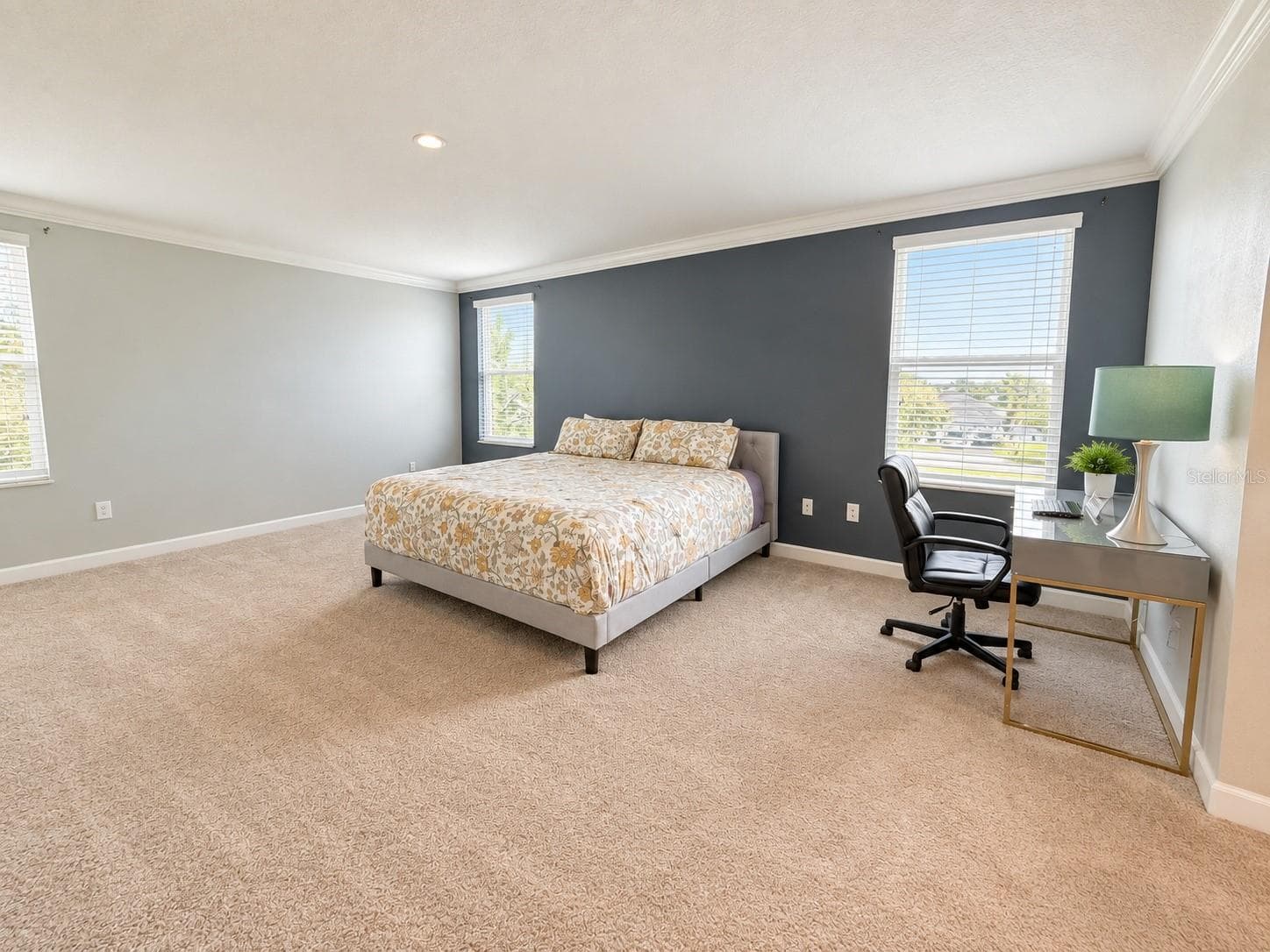 Generously sized primary suite with ample space for a complete bedroom retreat. - 1516 BUNKER DR, DAVENPORT