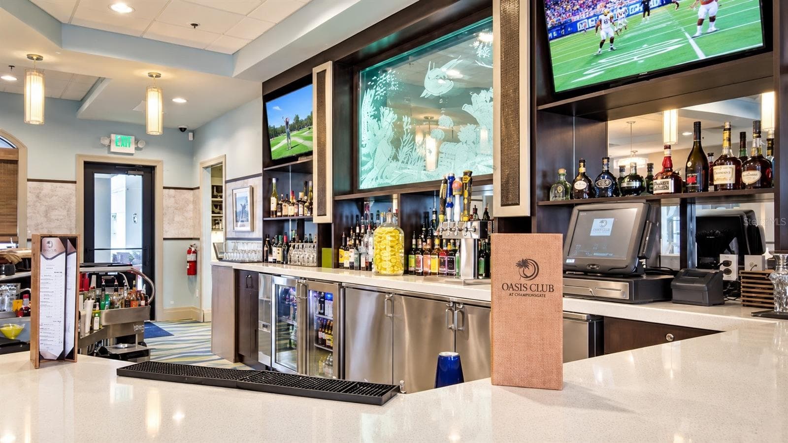 Oasis Club at ChampionsGate features a full-service bar and casual gathering space for residents and guests. - 1516 BUNKER DR, DAVENPORT