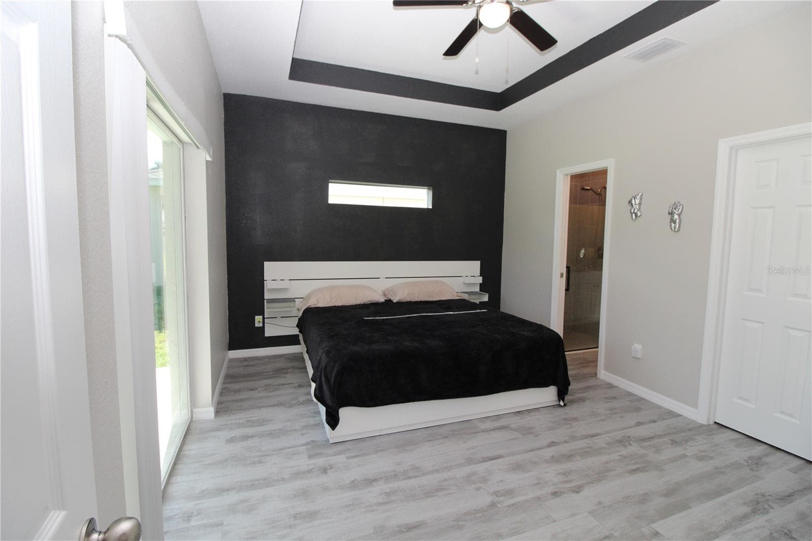 Primary Bedroom.... Accent wall with transom window for extra lighting.... - 1888 FRANKLIN LN, NORTH PORT