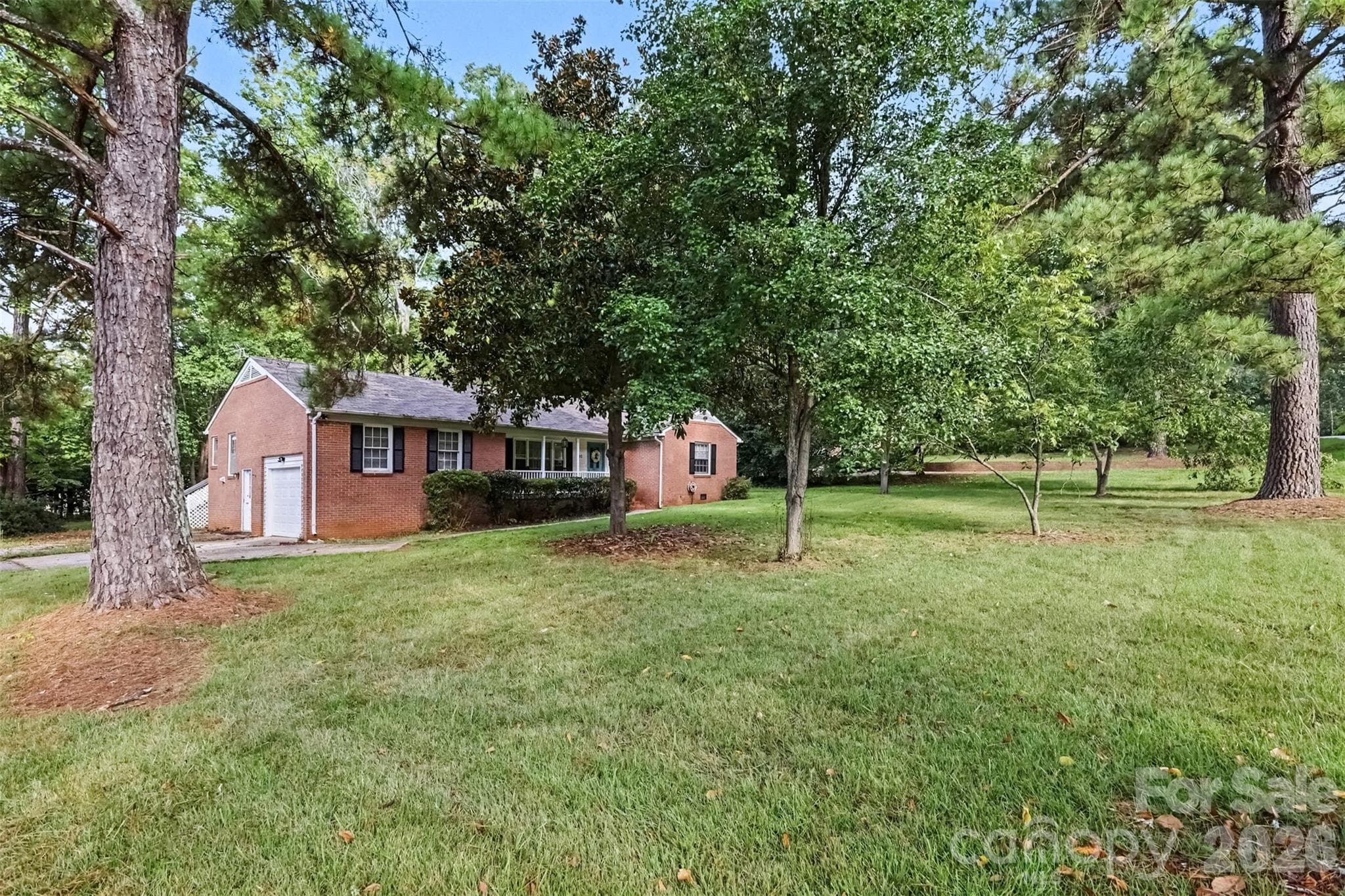 Set among mature trees with a big yard all around - 502 Plantation Road, Lancaster
