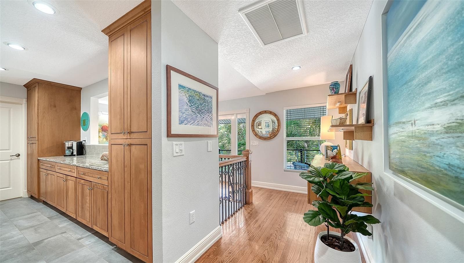 Open kitchen with custom wood cabinetry and abundant storage. - SARASOTA