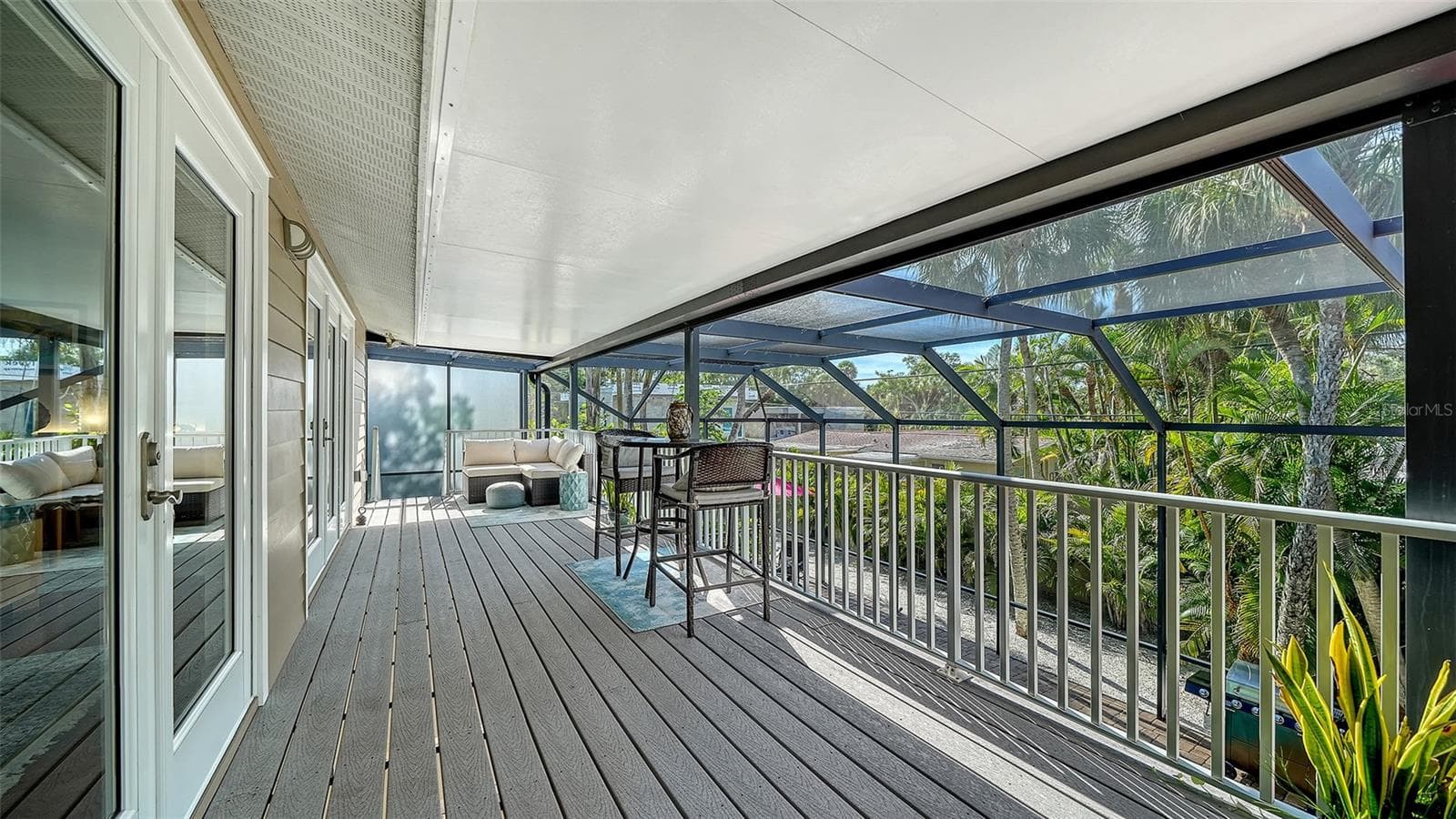 Covered screened balcony overlooking the tropical surroundings. - SARASOTA