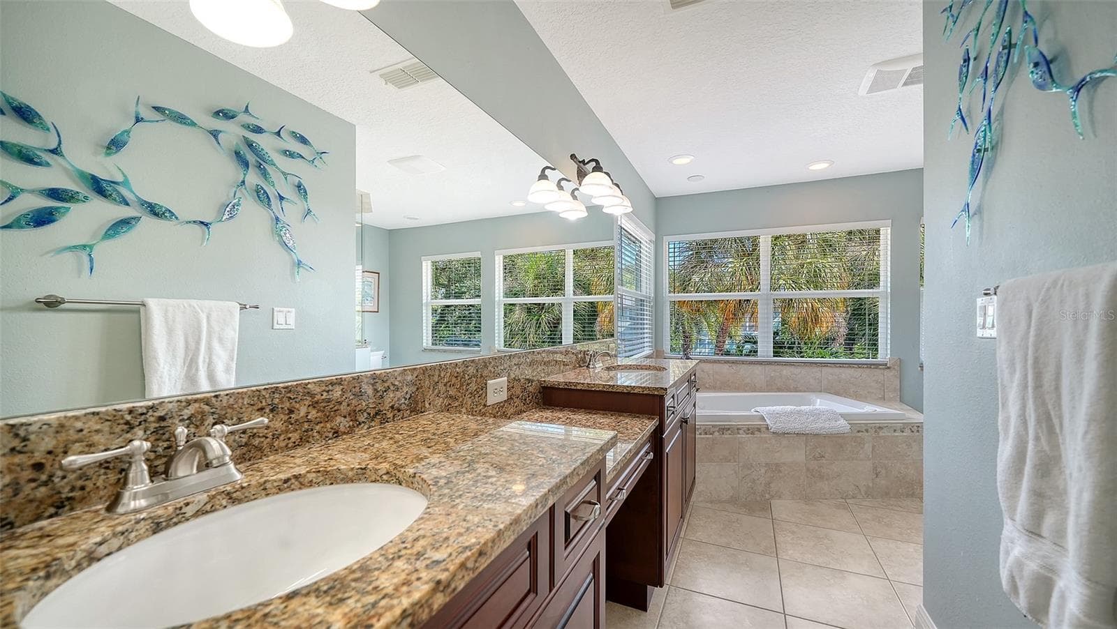 Primary bath with dual vanities, granite countertops and generous storage. - SARASOTA