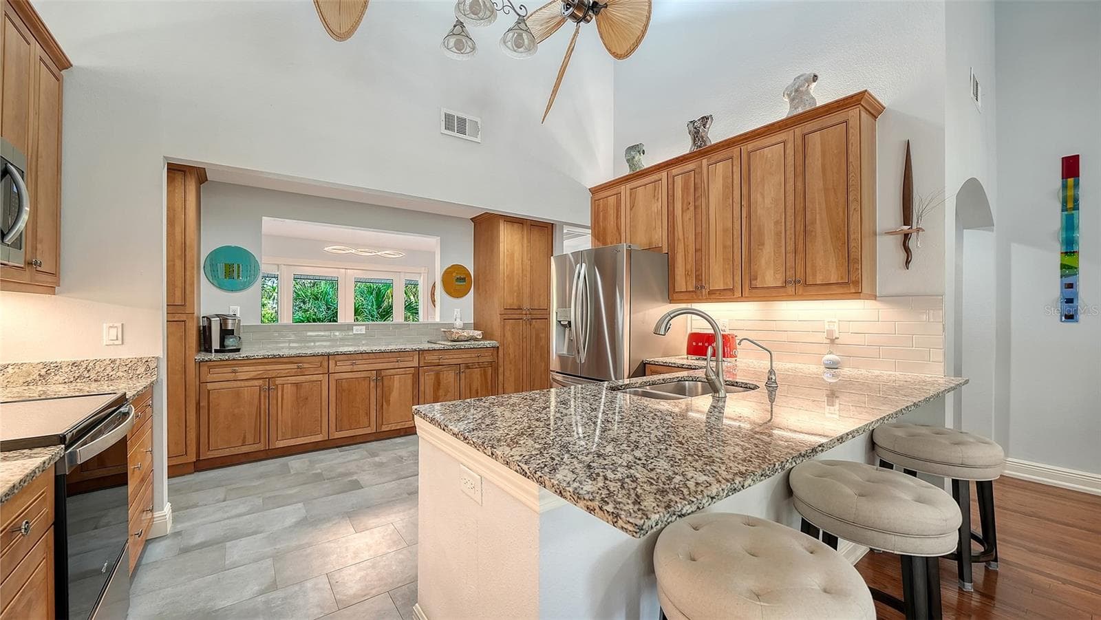 Kitchen opens directly to the main living spaces for effortless entertaining.Remodeled kitchen with granite countertops, custom cabinetry and stainless steel appliances. - SARASOTA